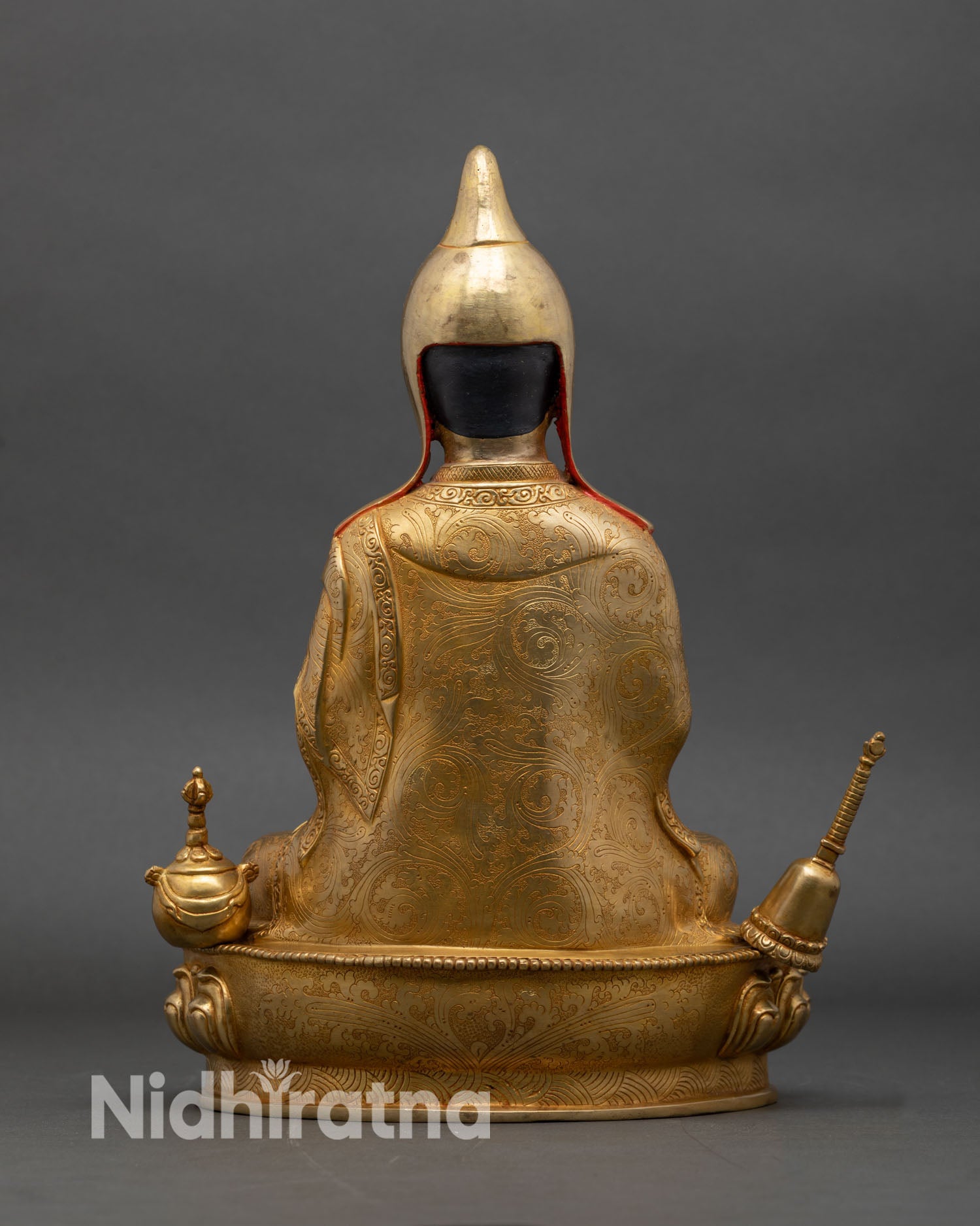 Back view of Atisha Buddhist master statue intricate floral scrollwork Nepal