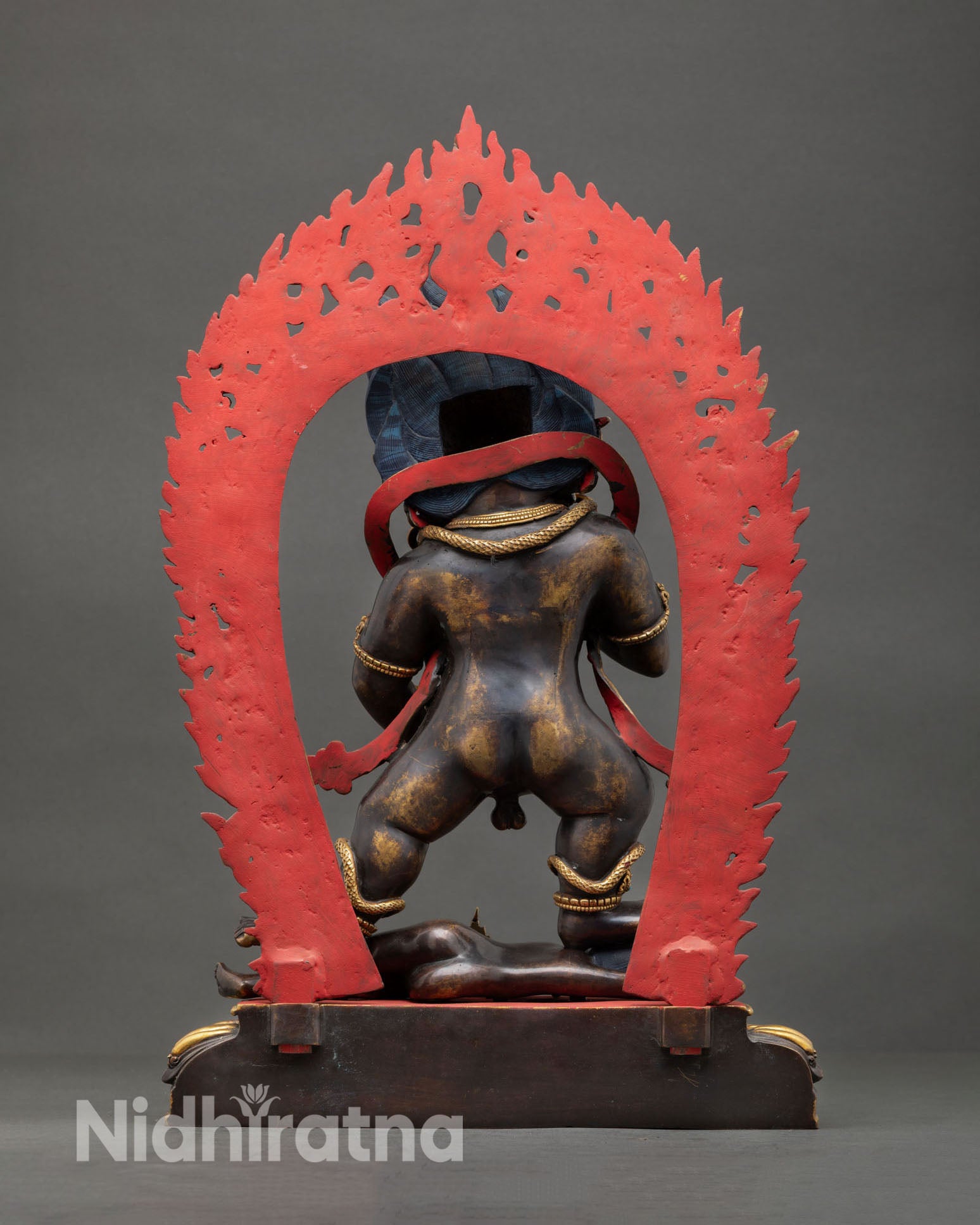 Back view of Black Dzambhala statue, copper metalwork, oxidized finish, gold ornaments, Nepal Newari craftsmanship