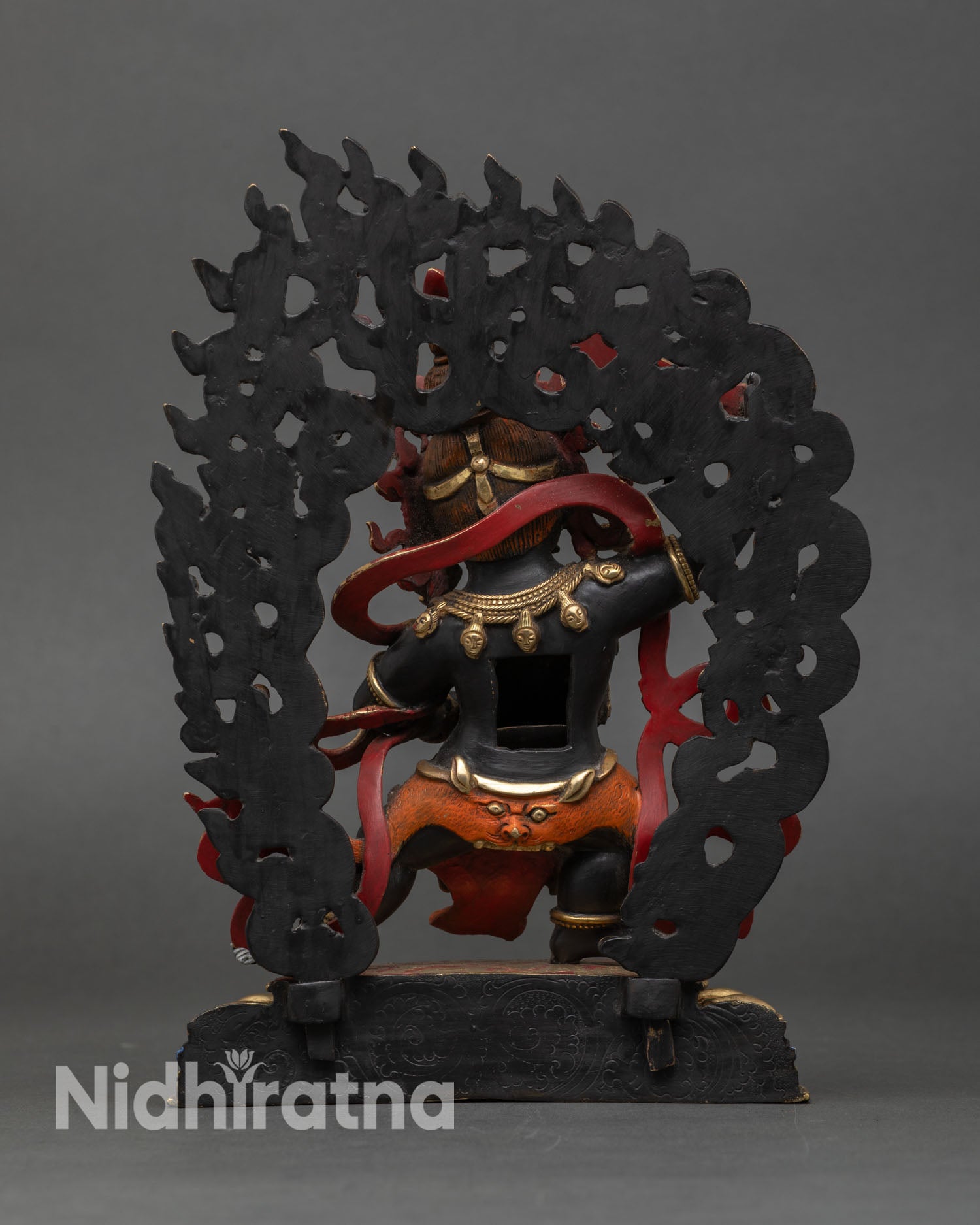 Back view of Black Manjushri Statue showing gold-gilded copper and sculpted details