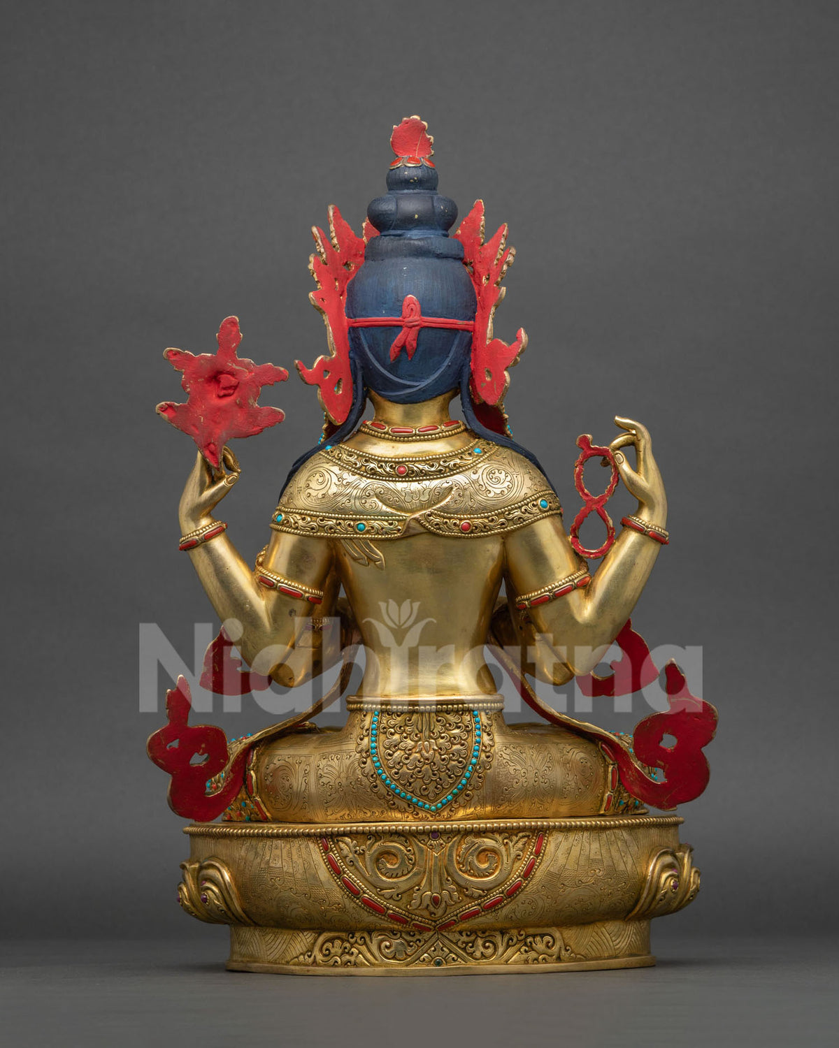 Back view of Chenrezig Avalokiteshvara copper statue showing lost-wax cast detail and floral halo