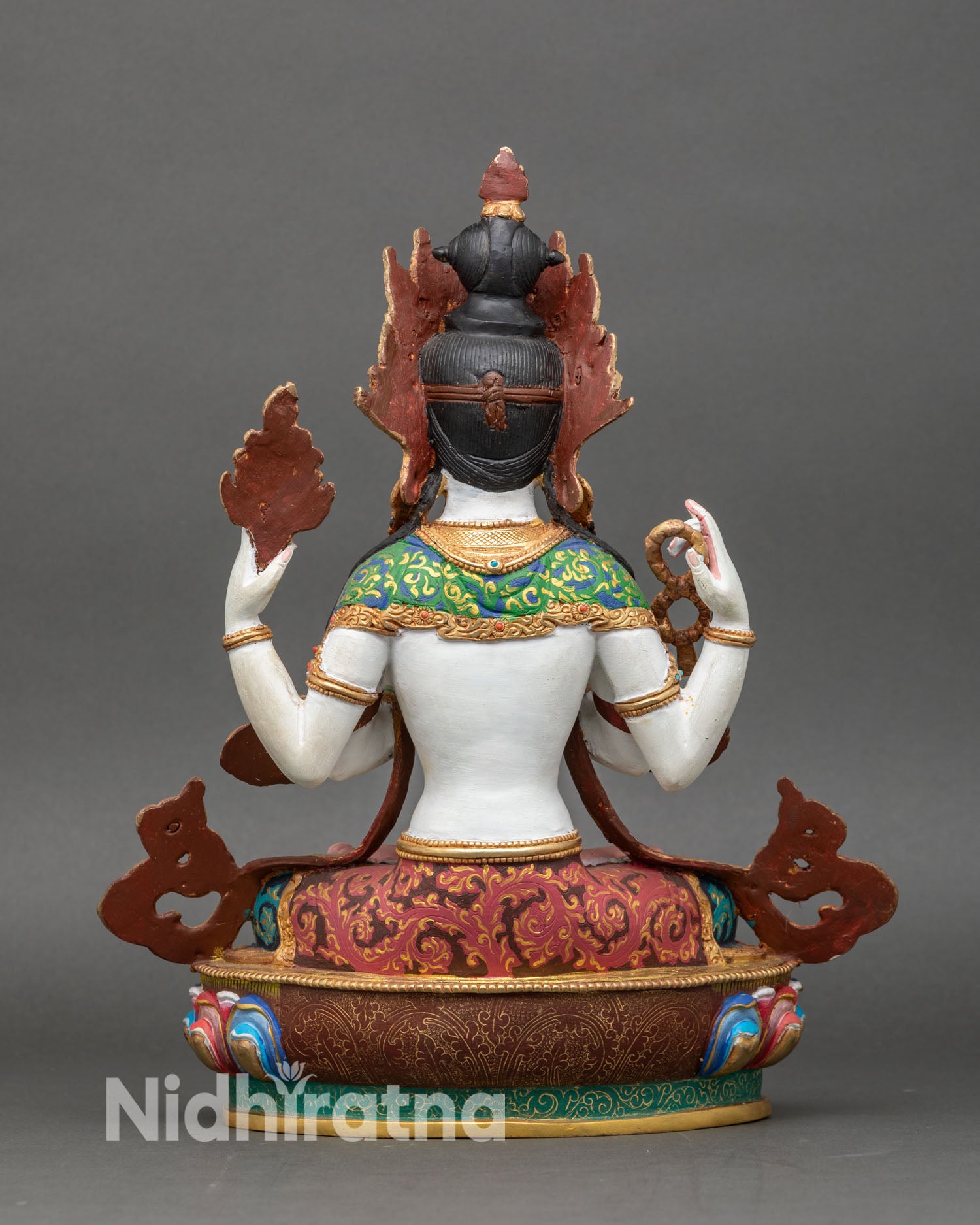 back view of chenrezig sculpture with detailed copper craftsmanship and gold highlights