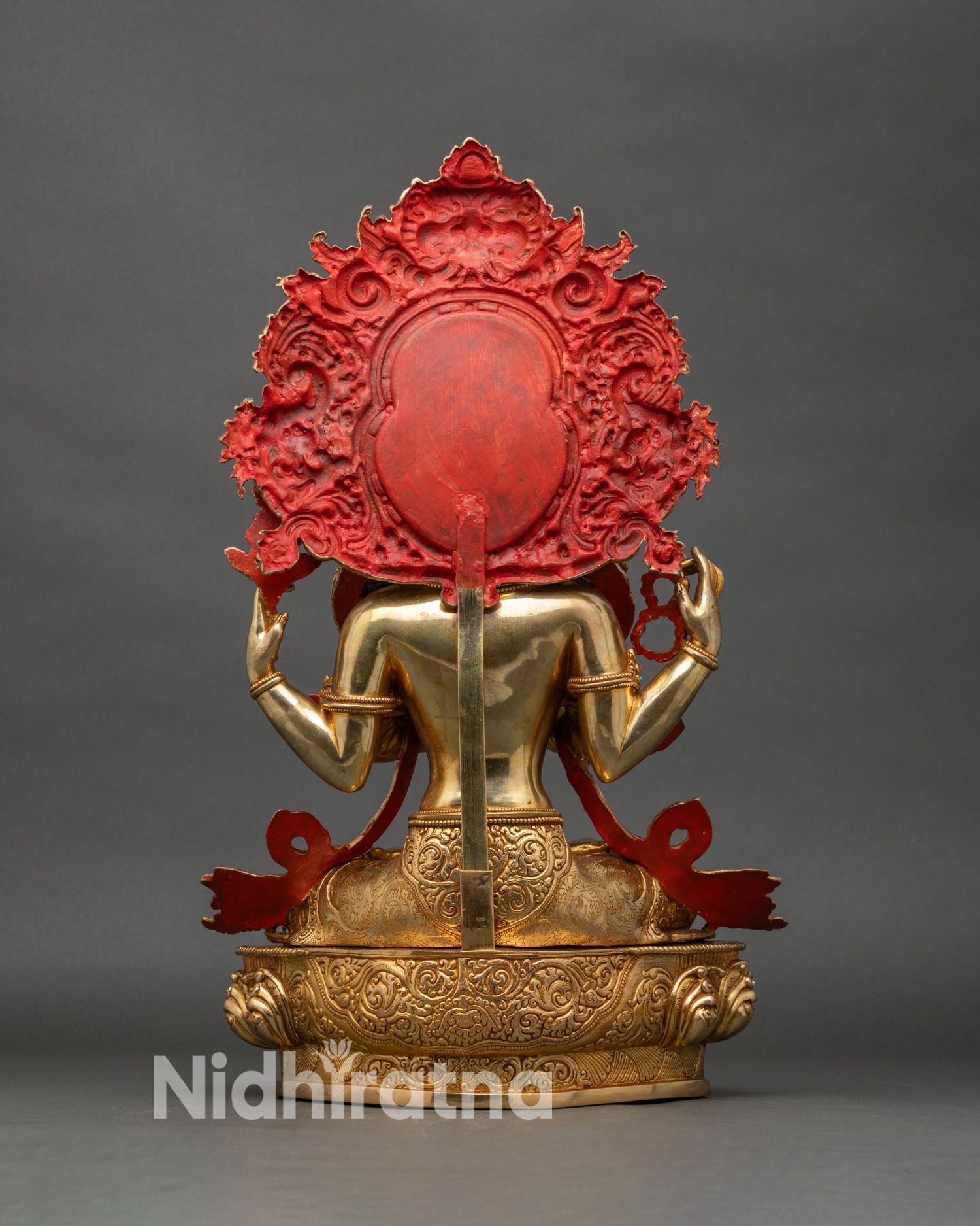 Back view of Chenrezig statue, ornate halo, twin makaras, garuda, lotus pedestal details