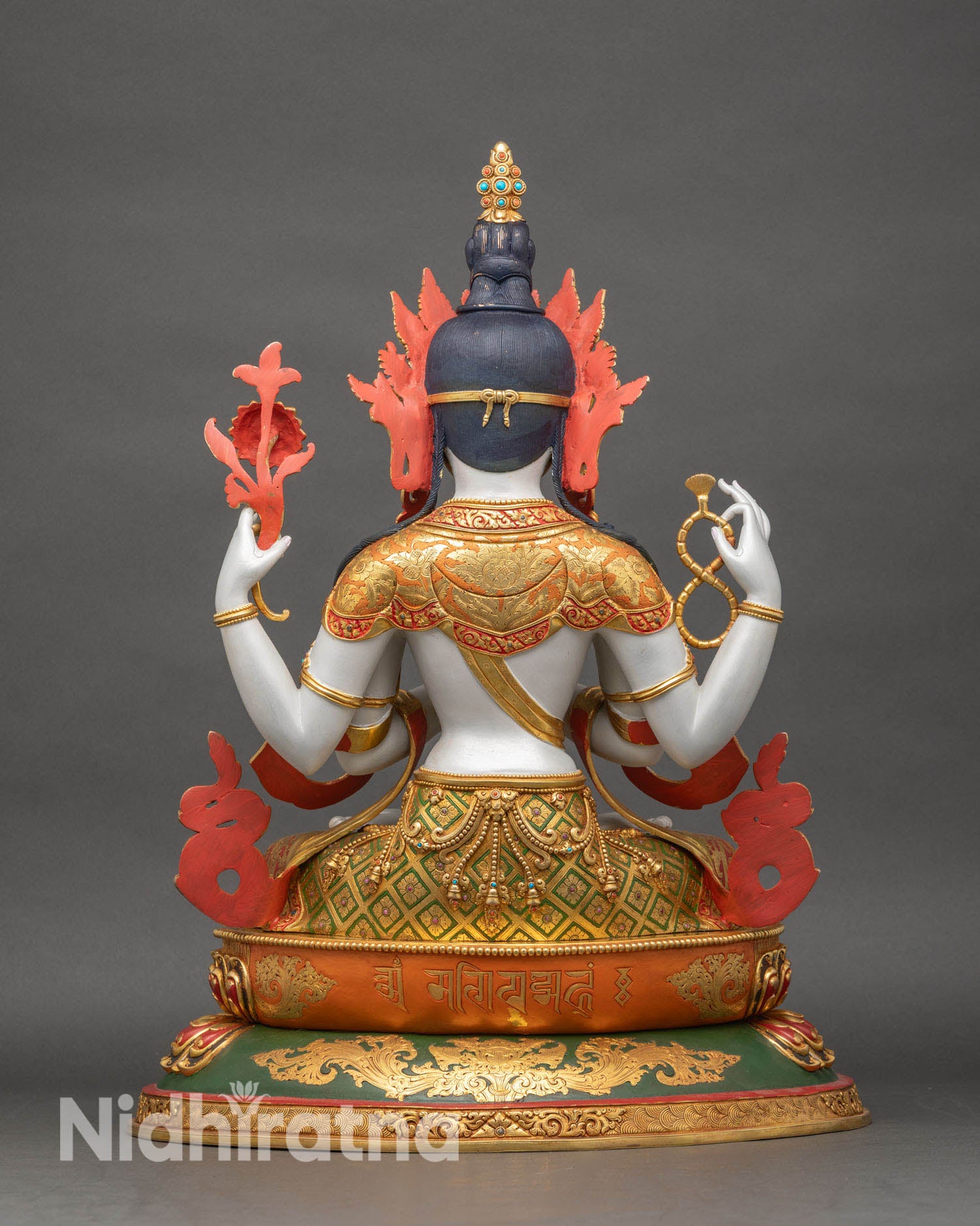Back view of Chenrezig statue showing detailed throne carving, robe patterns, and halo structure