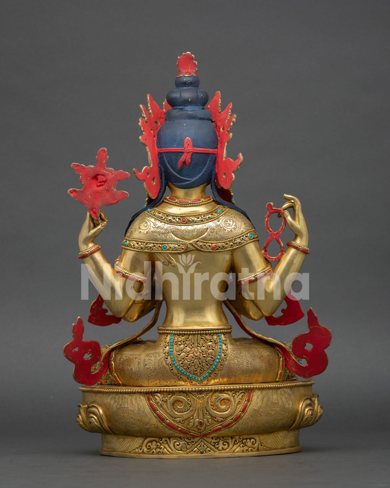 Back view of Chenrezig statue with detailed copper carving, lotus base, and Himalayan Buddhist artwork