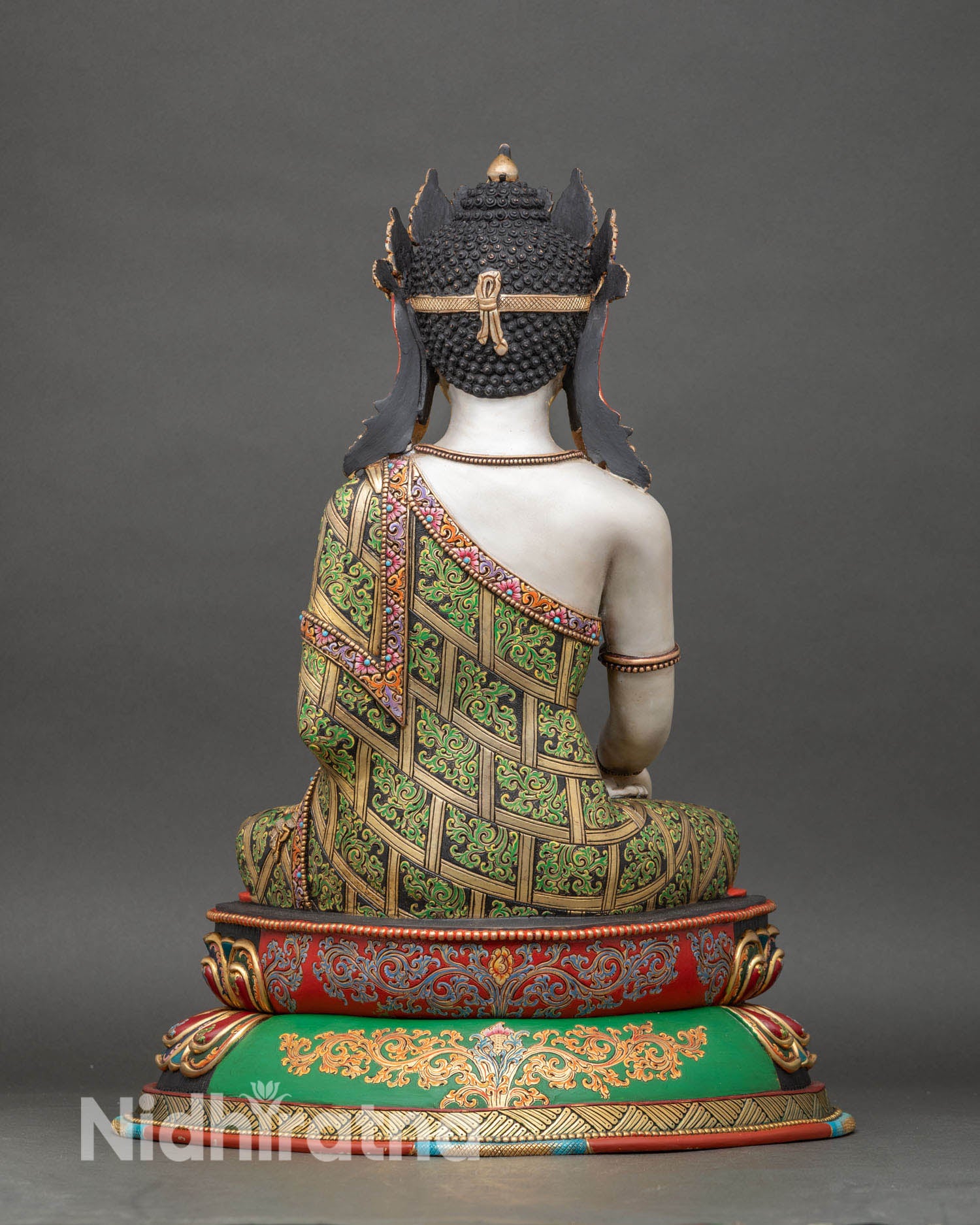 back view of crown shakyamuni buddha statue with decorated double-lotus pedestal and filigree robes