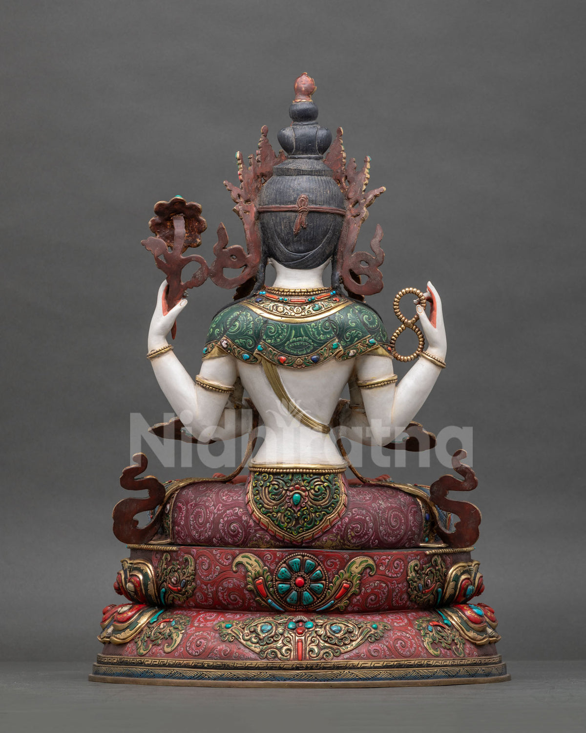 Back view of detailed copper craftsmanship on four-armed Chenrezig