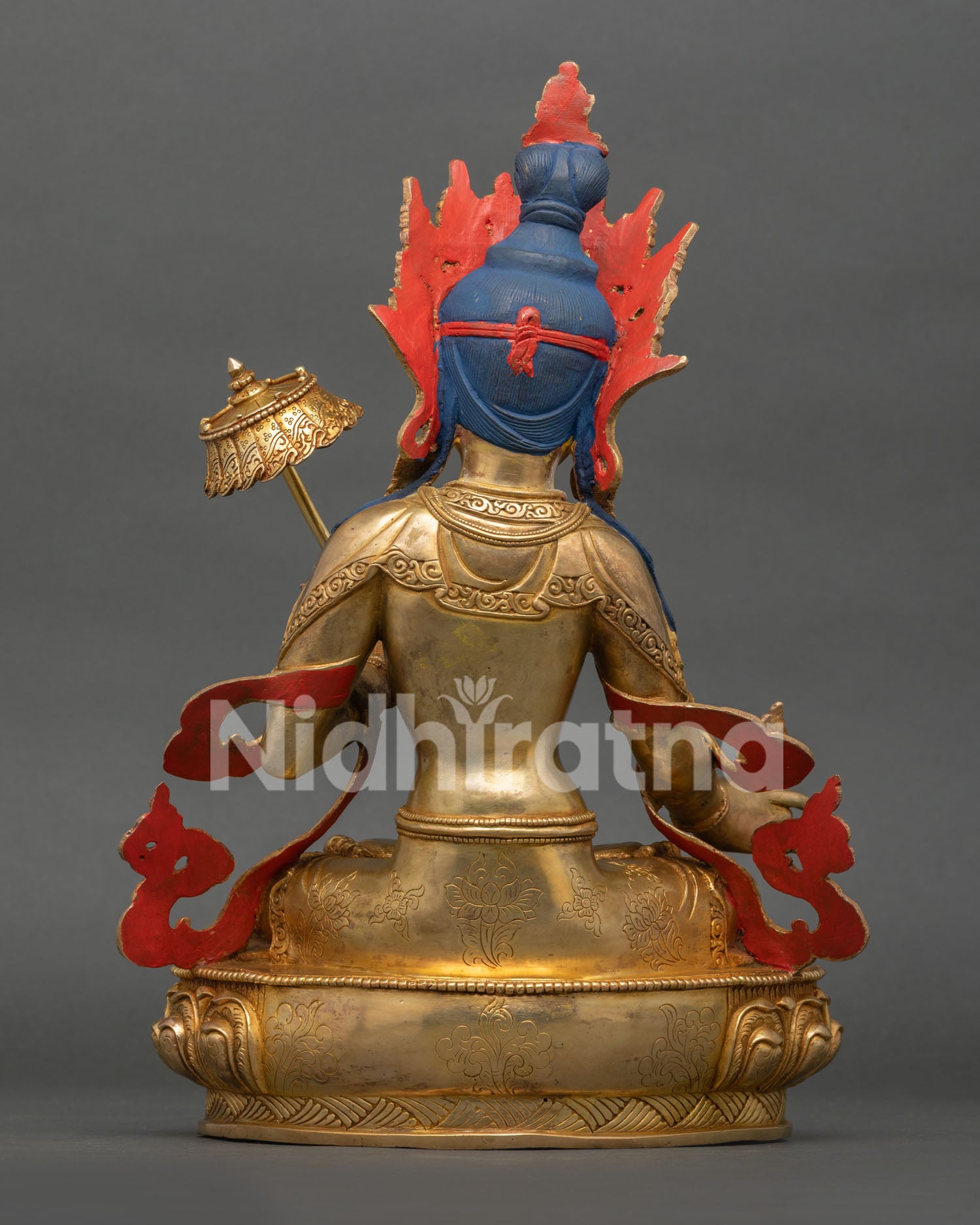 back view of dukar statue with detailed robes and repoussé artwork