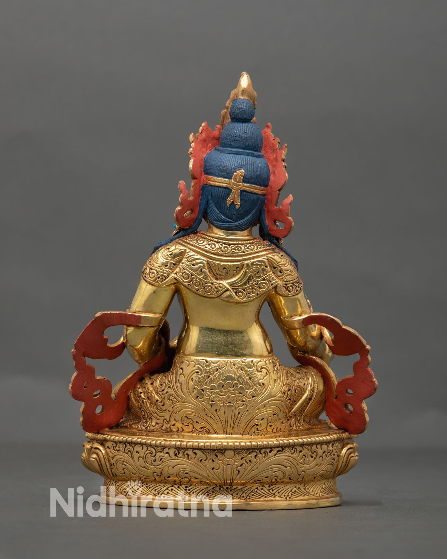 Back view of Dzambhala Buddhist wealth deity statue with finely engraved lotus pedestal and traditional Nepalese craftsmanship