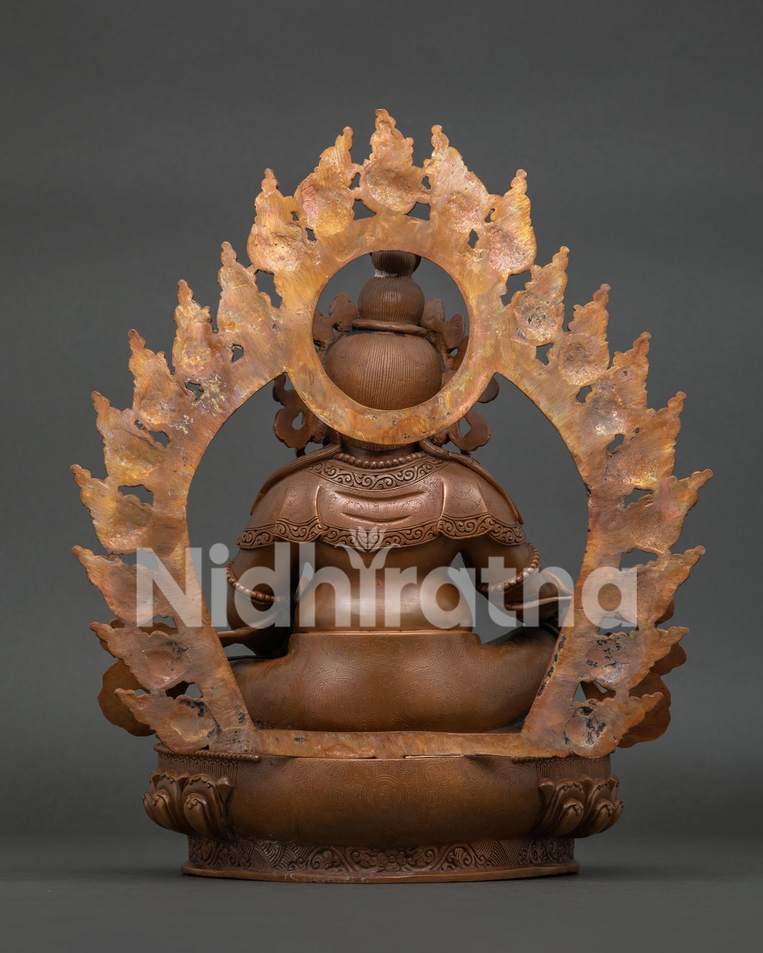 Back view of Dzambhala statue with detailed carvings and traditional Newari craftsmanship