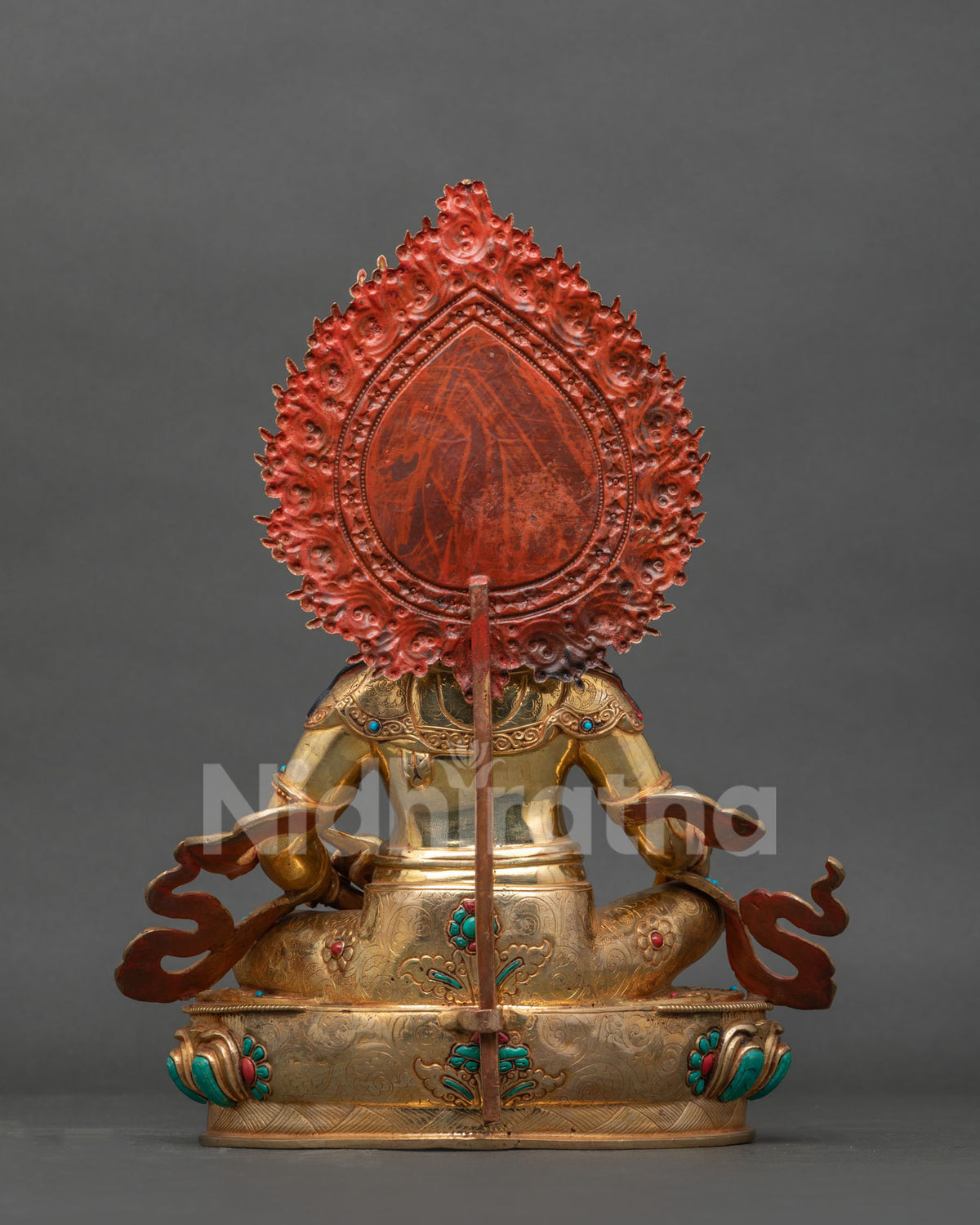 Back view of Dzambhala statue with engraved gold-gilded robe and red-painted halo