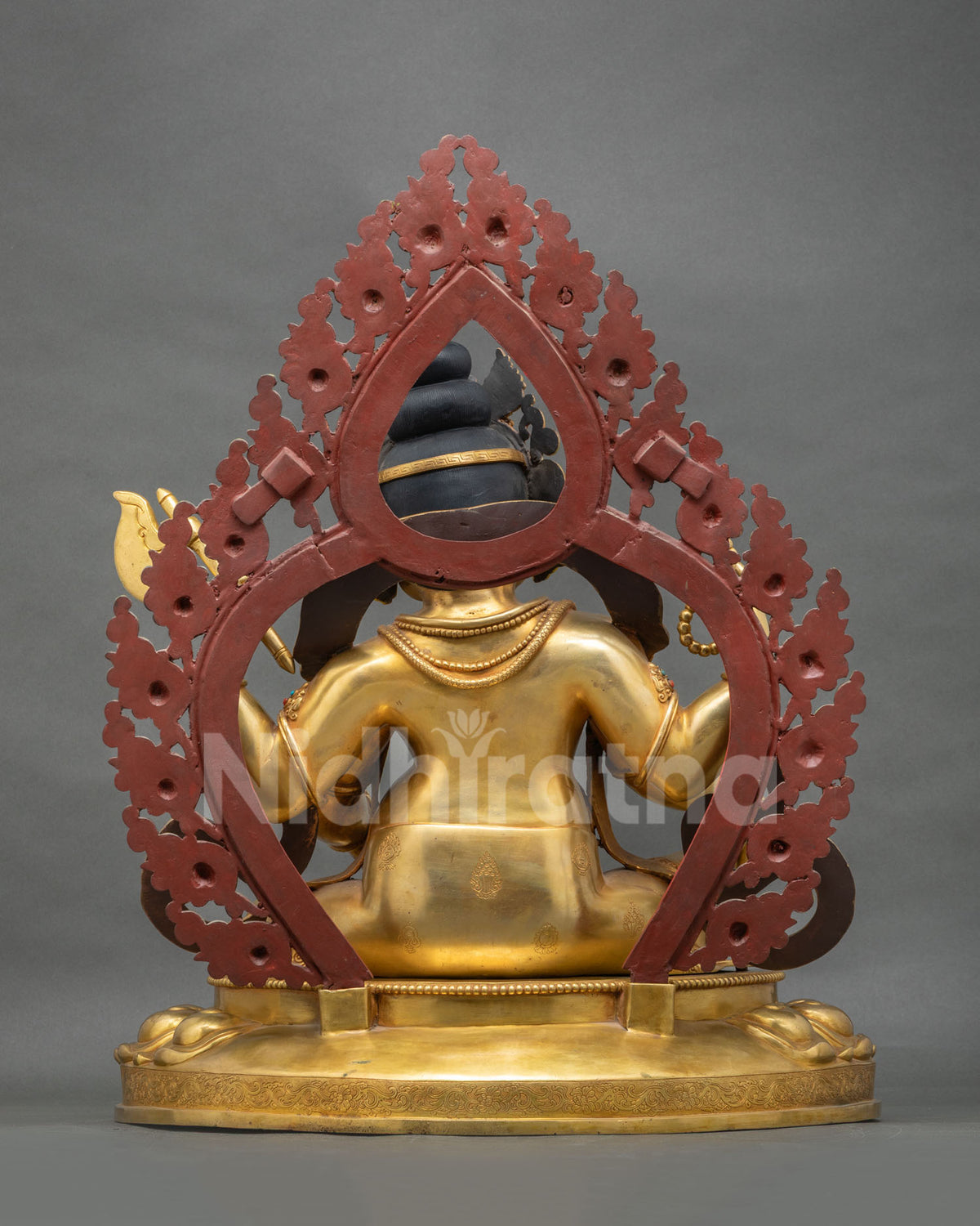 Back view of Ganesh statue with red halo and gold fire-gilded copper body, lost-wax cast in Nepal