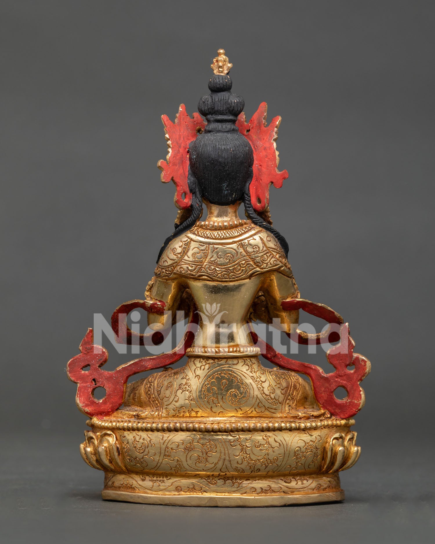 Back view of gold gilded Vajradhara statue showcasing traditional lost wax casting and Himalayan metalwork.