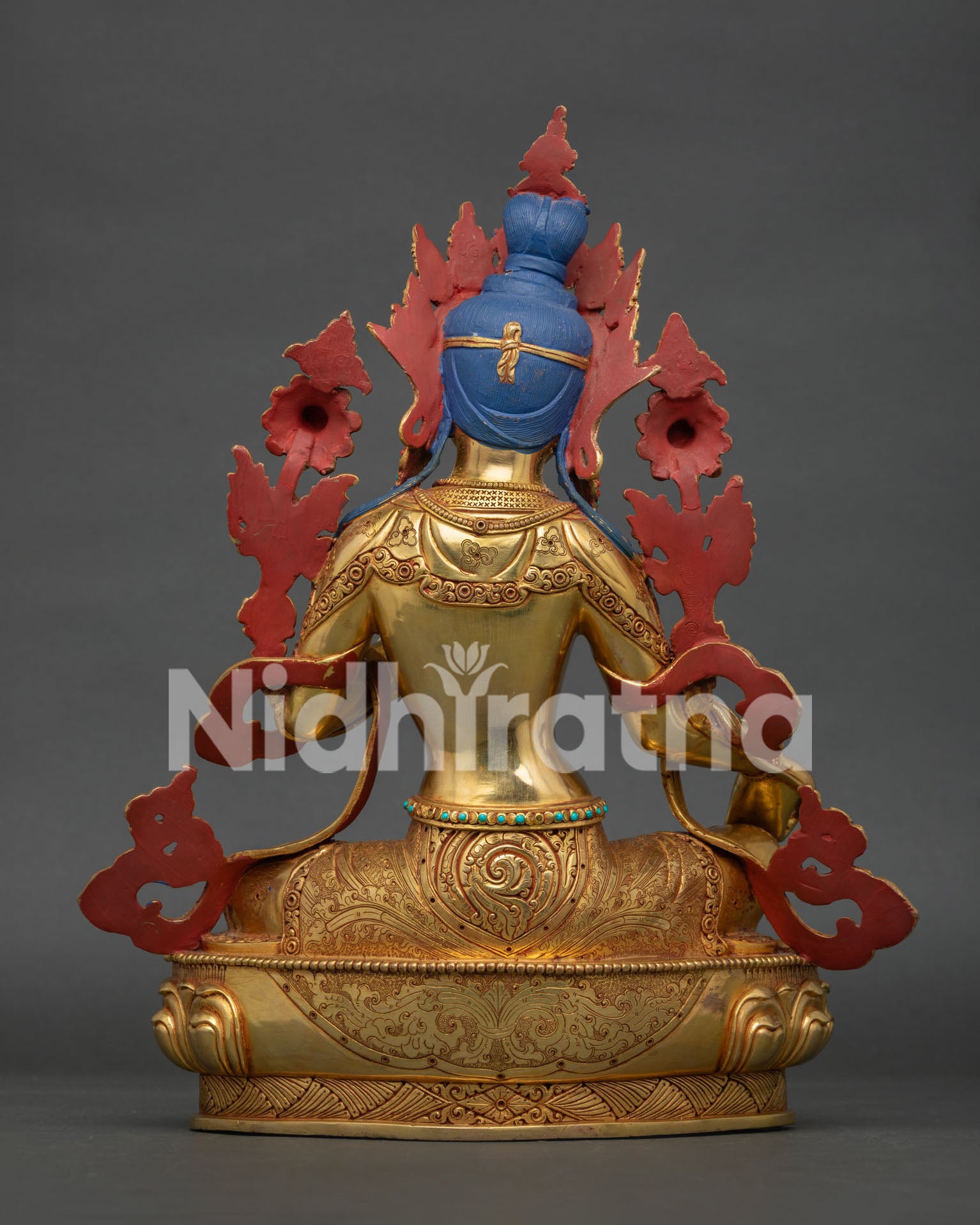 Back view of Green Tara Buddhist statue with detailed copper craftsmanship and traditional Himalayan design