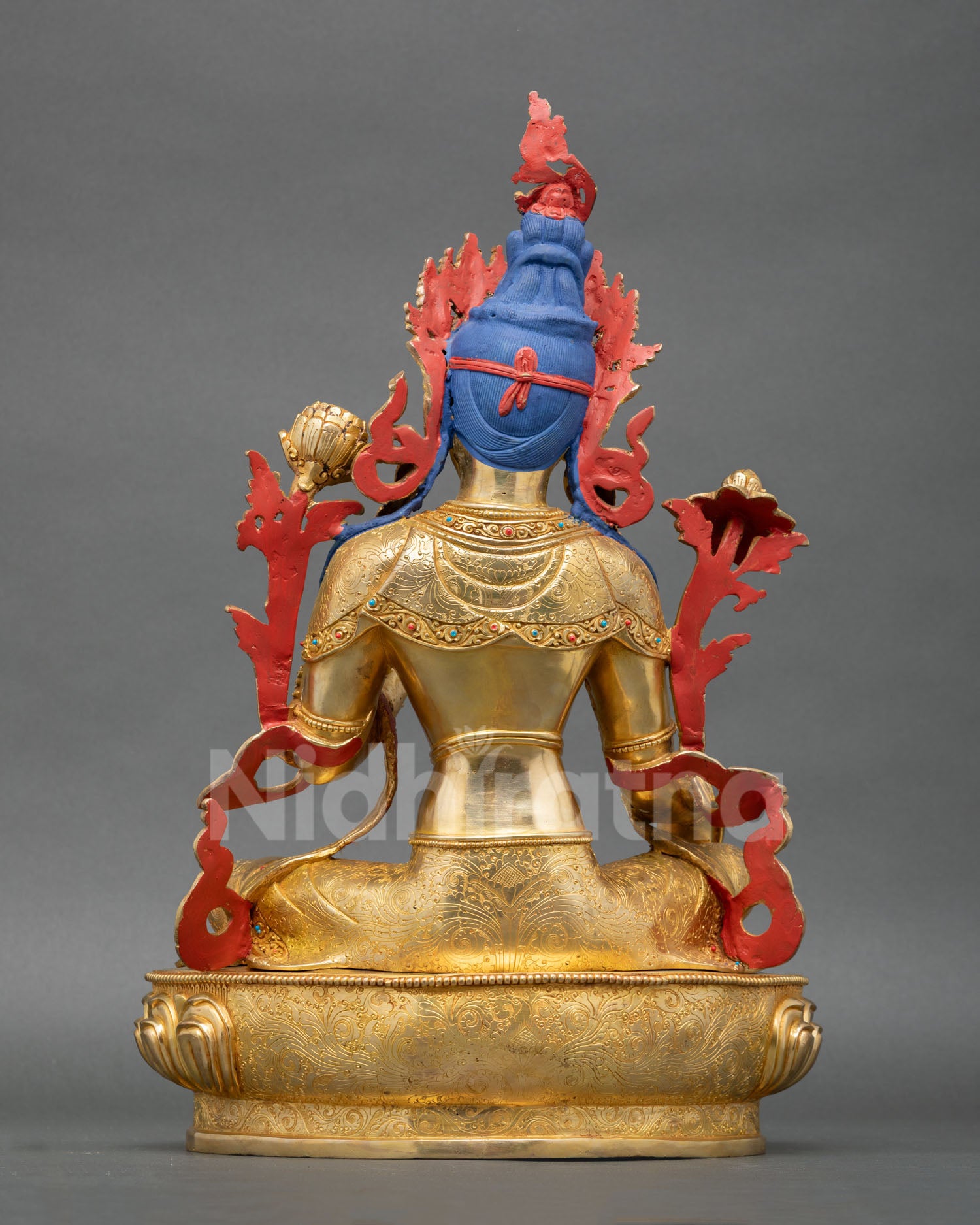 Back view of Green Tara Buddhist statue with detailed robes and sacred lotus pedestal