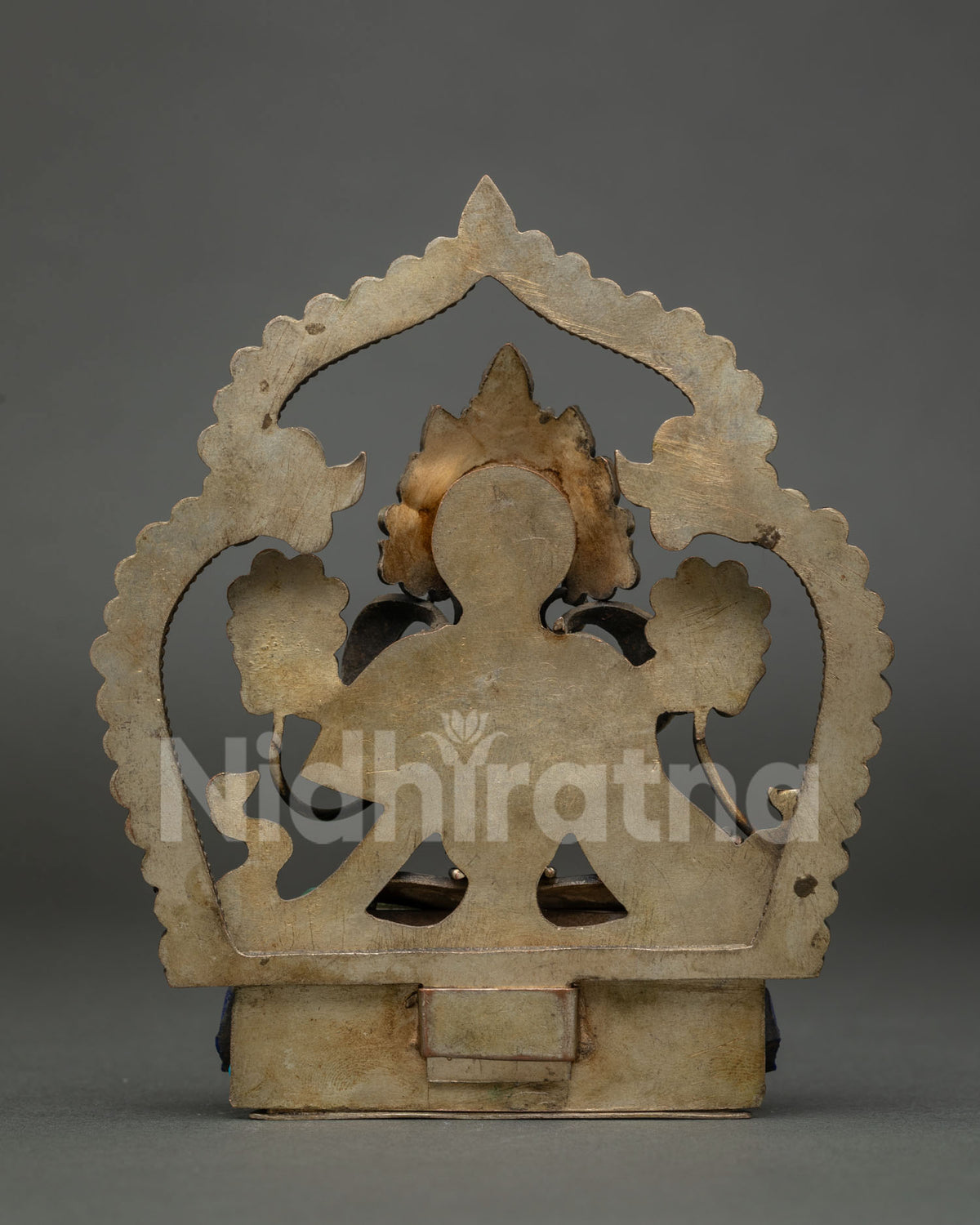 Back view of Green Tara copper statue showing handcrafted halo and pedestal from Nepal