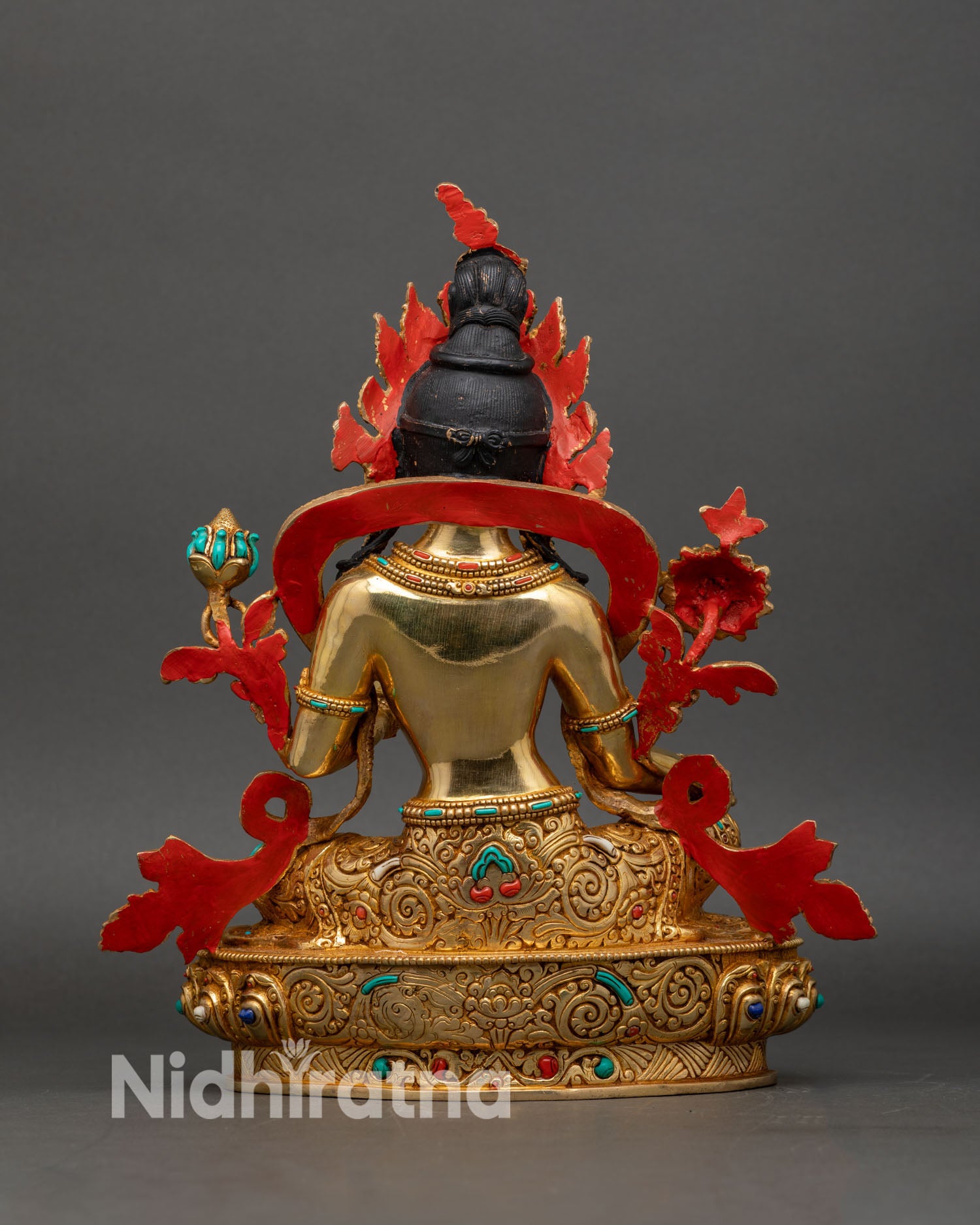 back view of green tara statue, engraved lotus throne and detailed craftsmanship in copper and gold