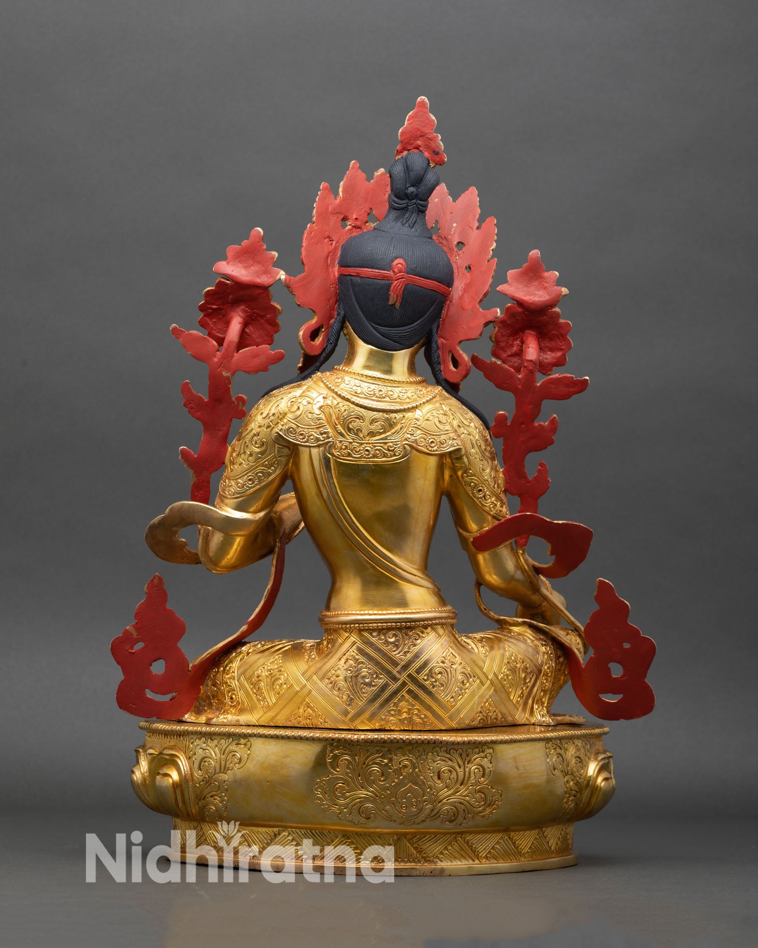 Back view of Green Tara statue flowing robes and intricate hand engraving