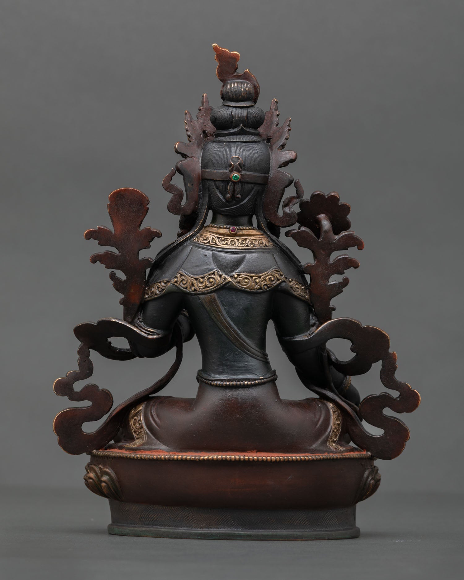 Back view of Green Tara statue highlighting intricate Himalayan artistry copper detailing and traditional hand painted finish.