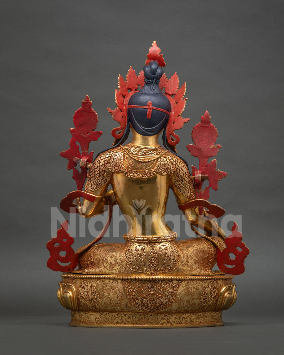 Back view of Green Tara statue showing crown detail and hair carving