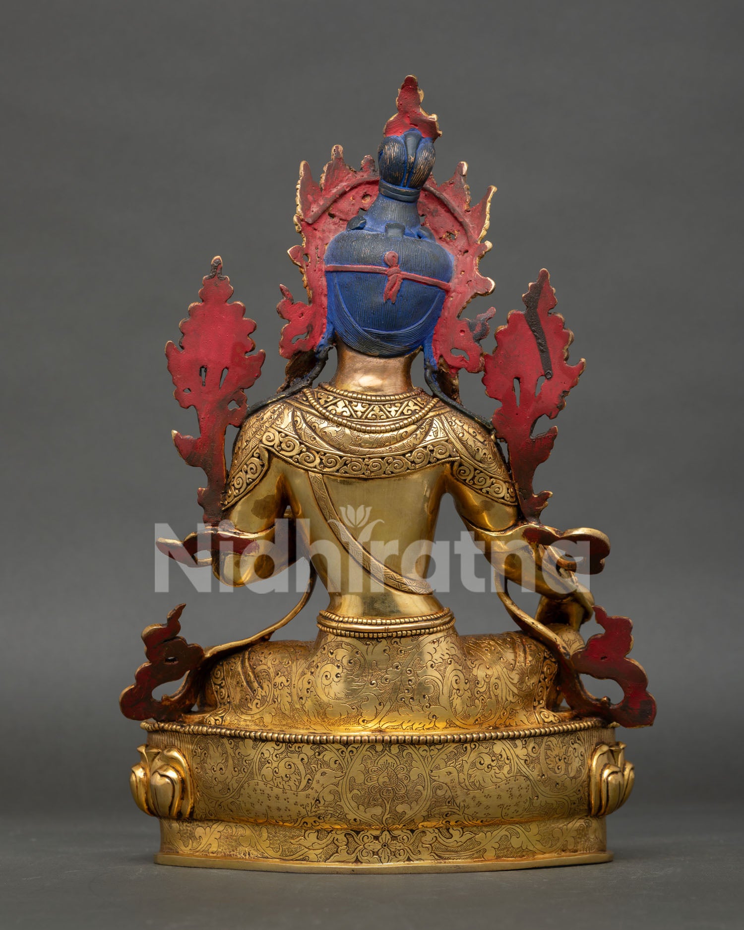 back view of green tara statue showing detailed ornaments and lotus throne engraving