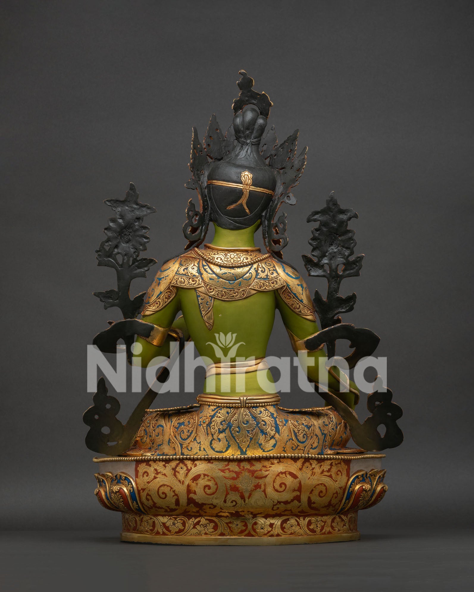 Back view of Green Tara statue showing detailed robe lotus throne and intricate copper craftsmanship
