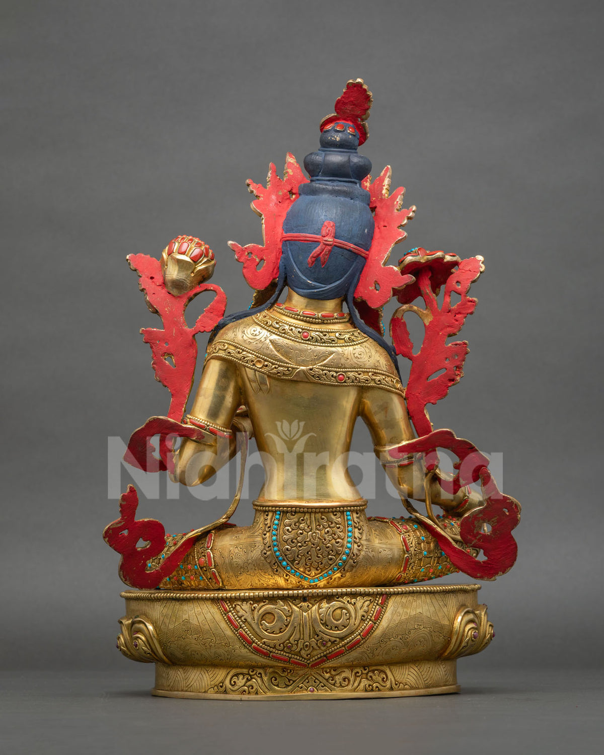 Back view of Green Tara statue showing engraved garments and lotus throne in gold fire-gilded copper
