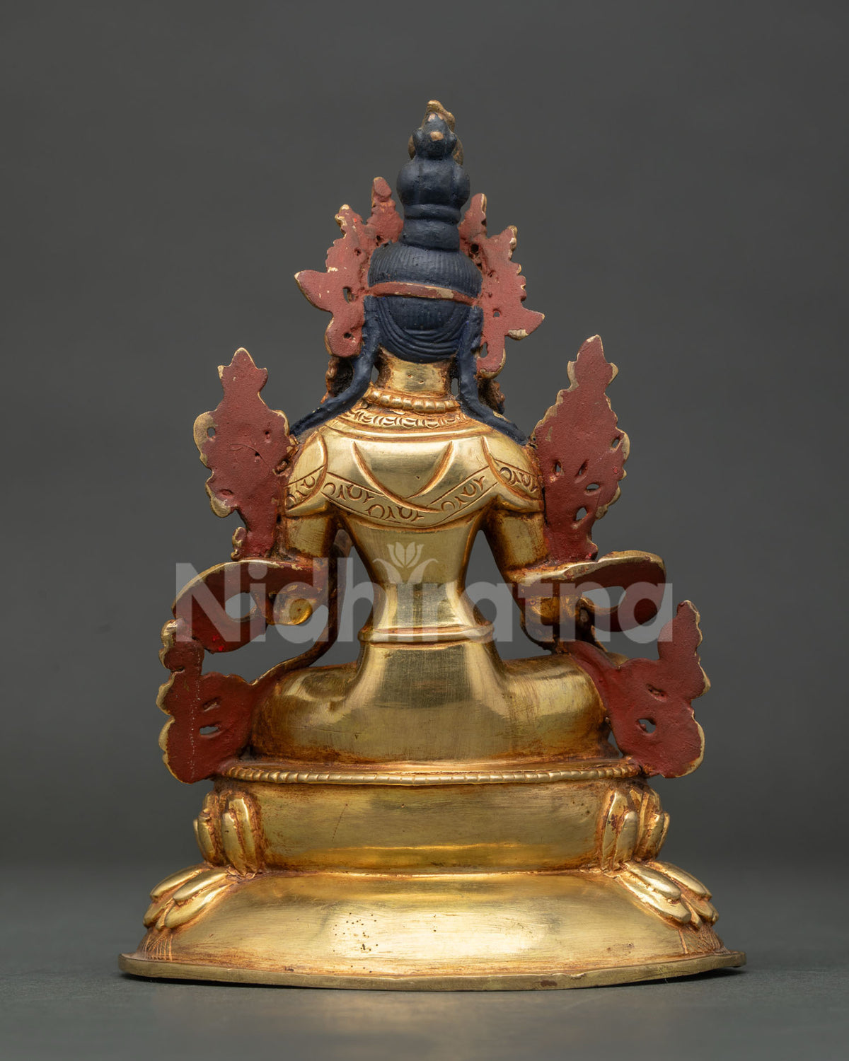 Back view of Green Tara statue showing red painted backing and gold detail, order yours today