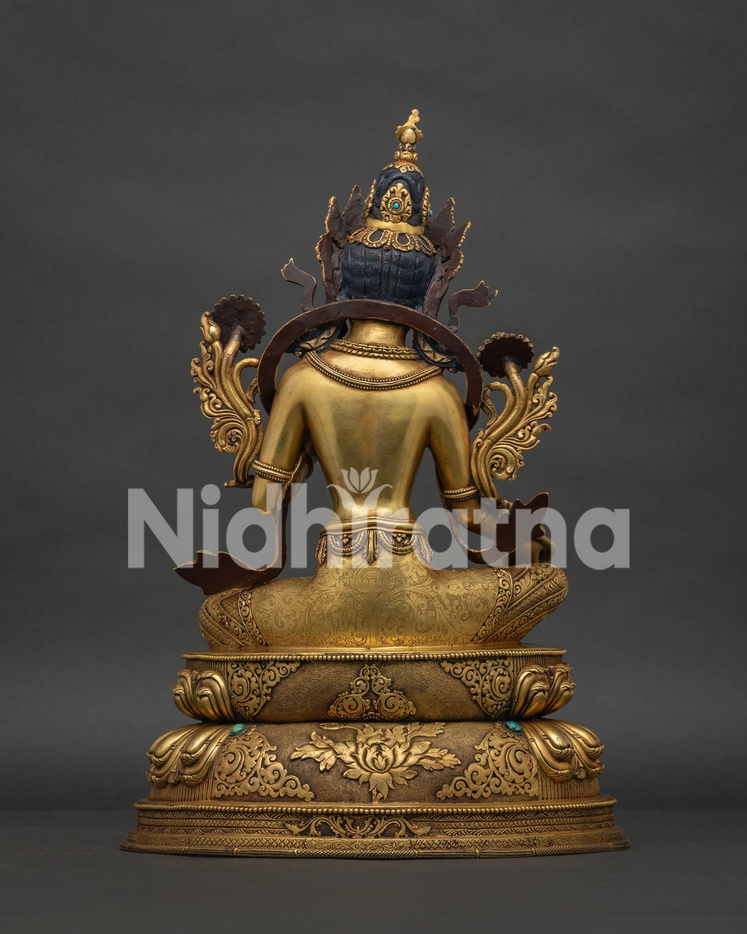 Back view of Green Tara statue with intricate copper craftsmanship and ornaments