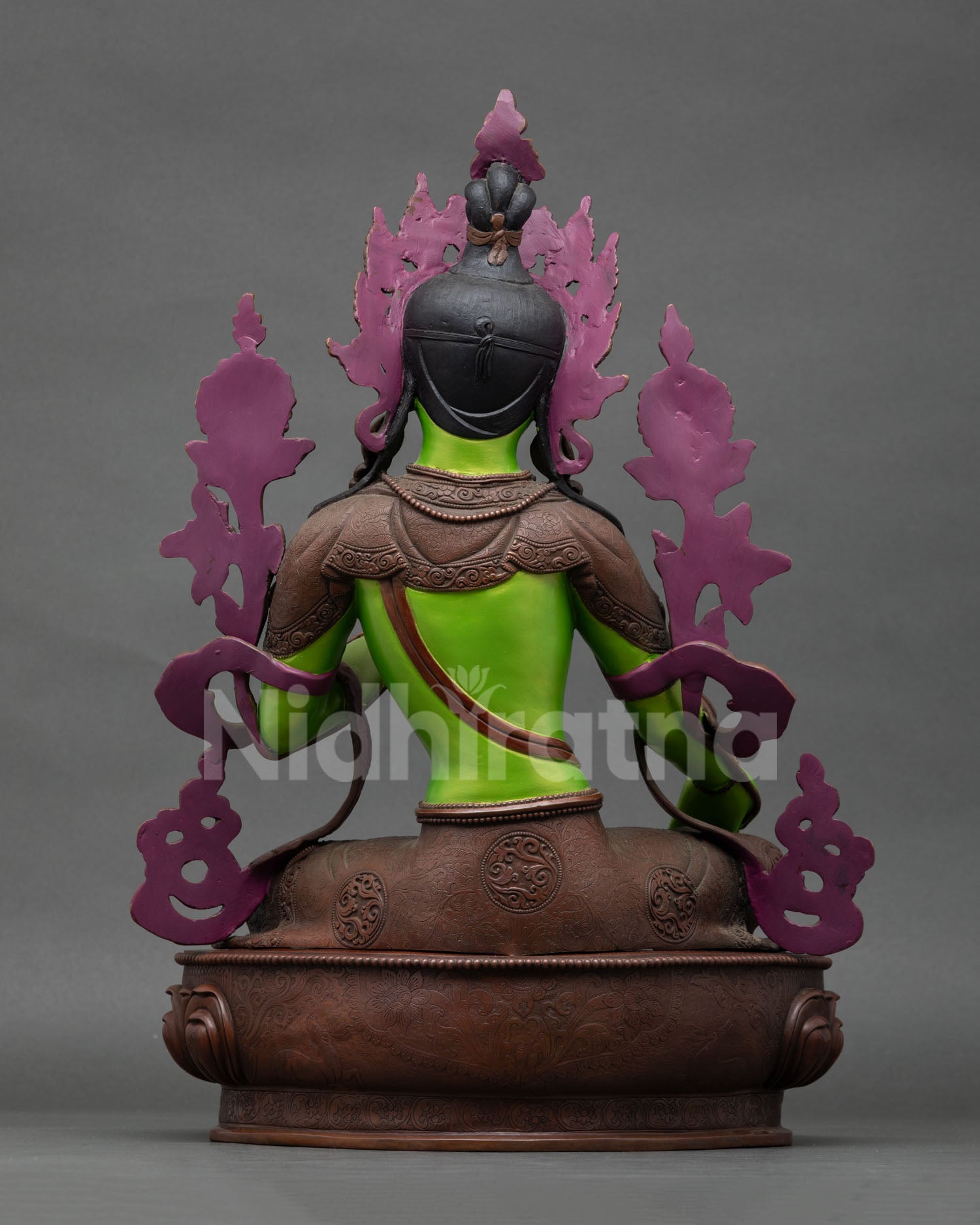 back view of green tara statue with ornate craftsmanship and lotus pedestal details