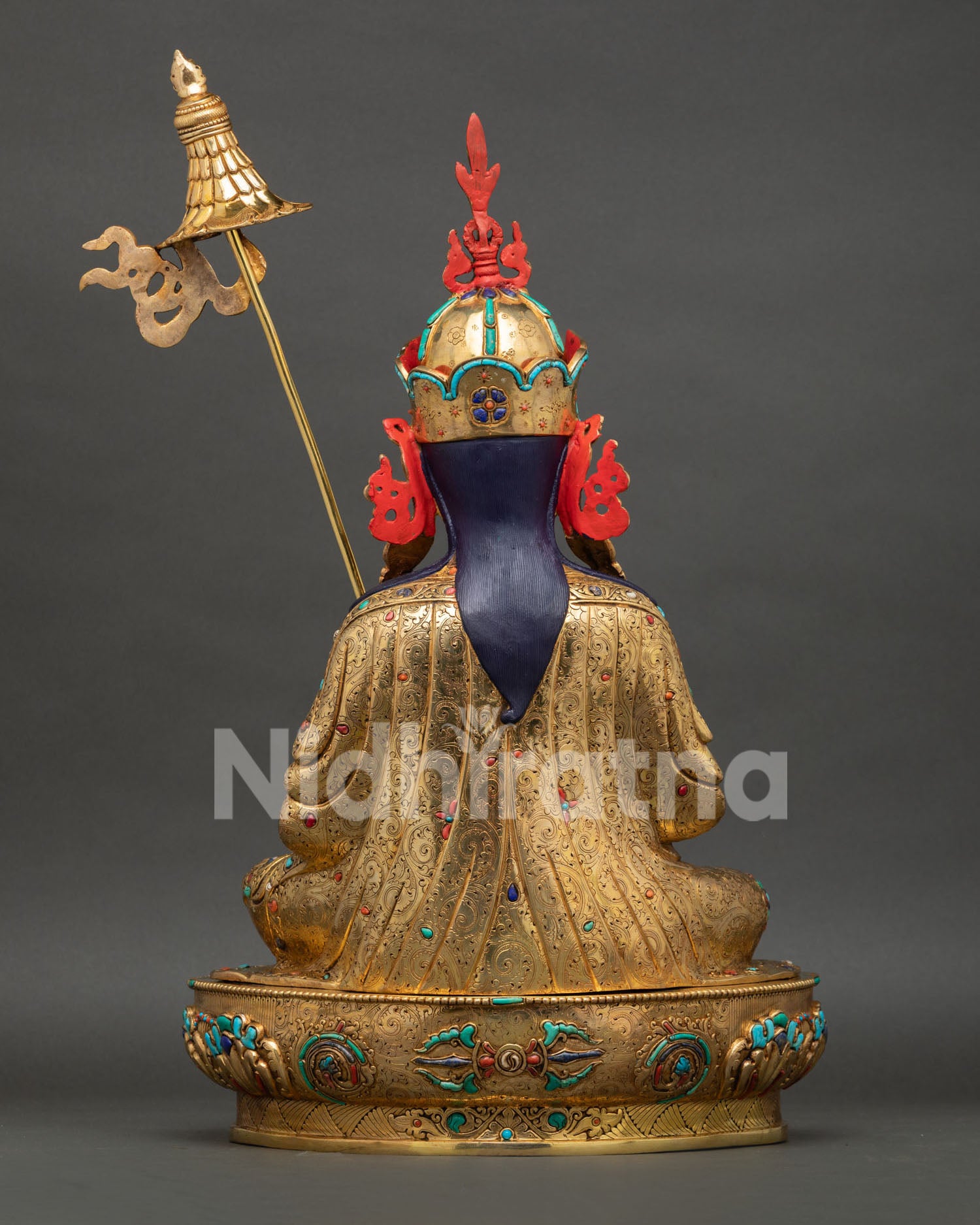 back view of guru orgyen norlha statue showing intricate carvings, gold ornaments, and lotus pedestal craftsmanship