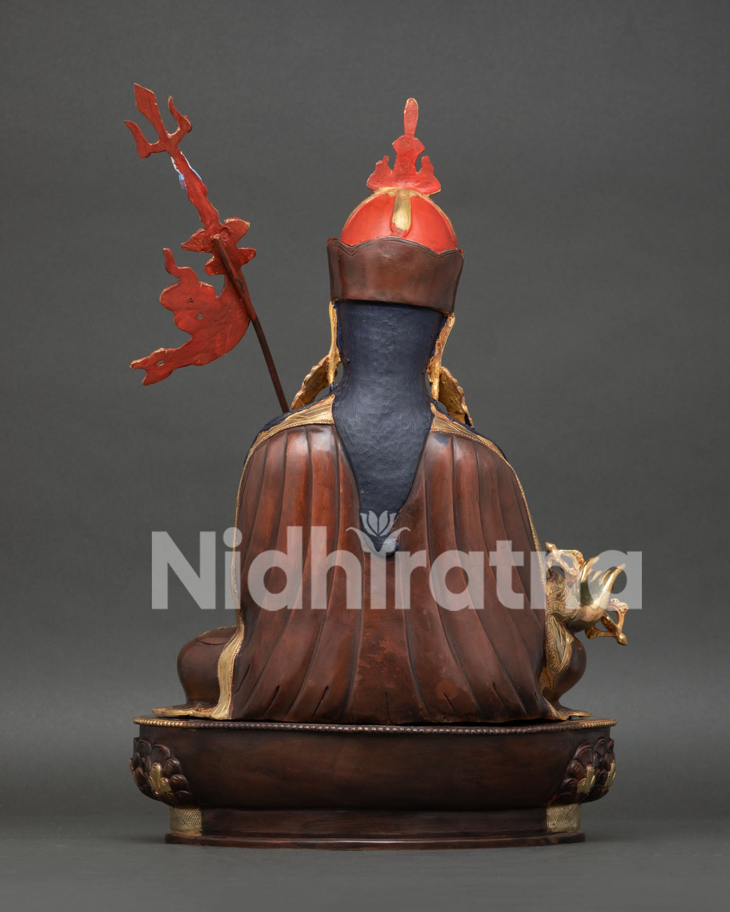 Back view of Guru Padmasambhava Statue showcasing gold fire-gilded copper body, red lotus hat, and intricate craftsmanship.