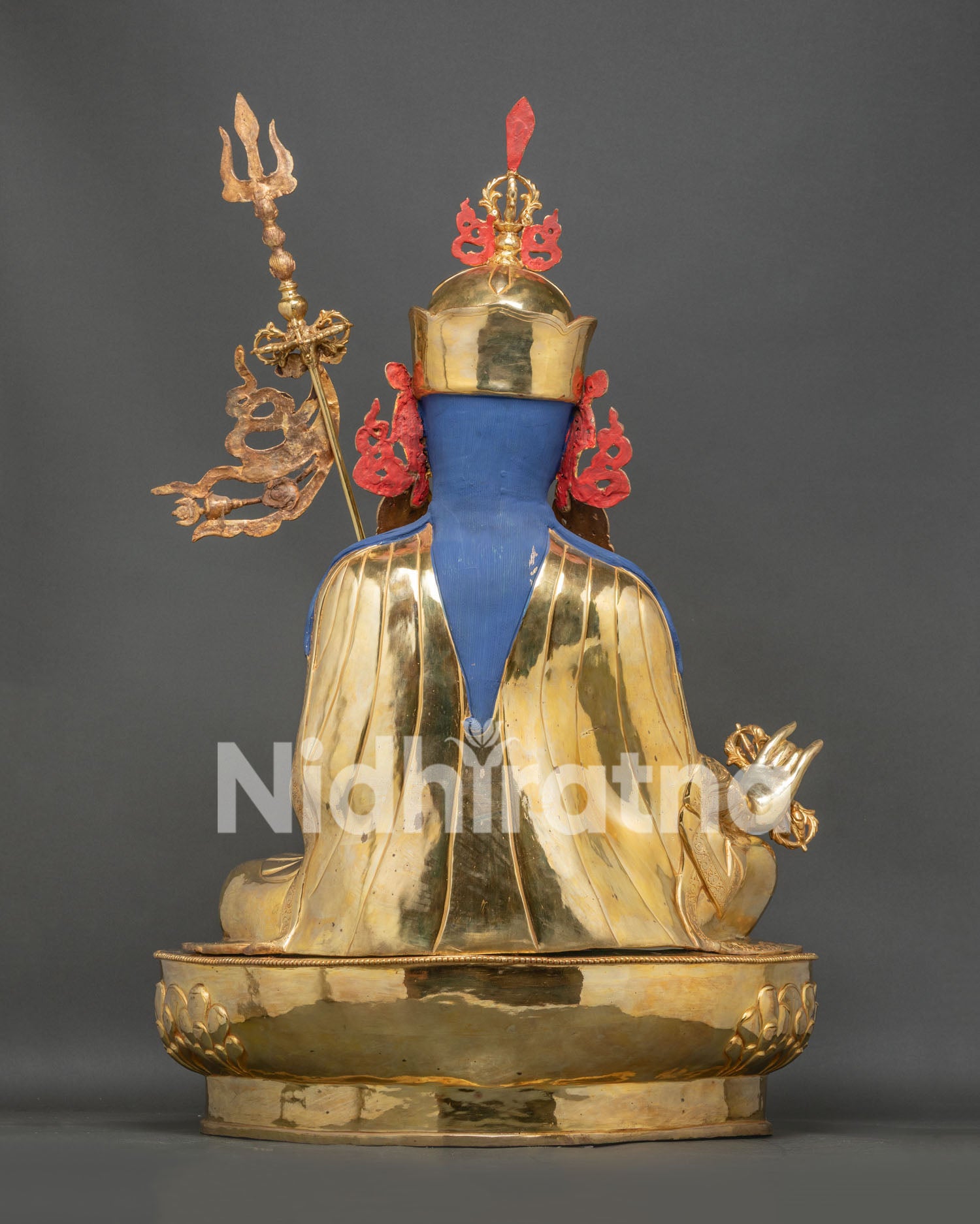 Back view of Guru Rinpoche statue showing royal robes, blue hair and detailed handcrafted metalwork