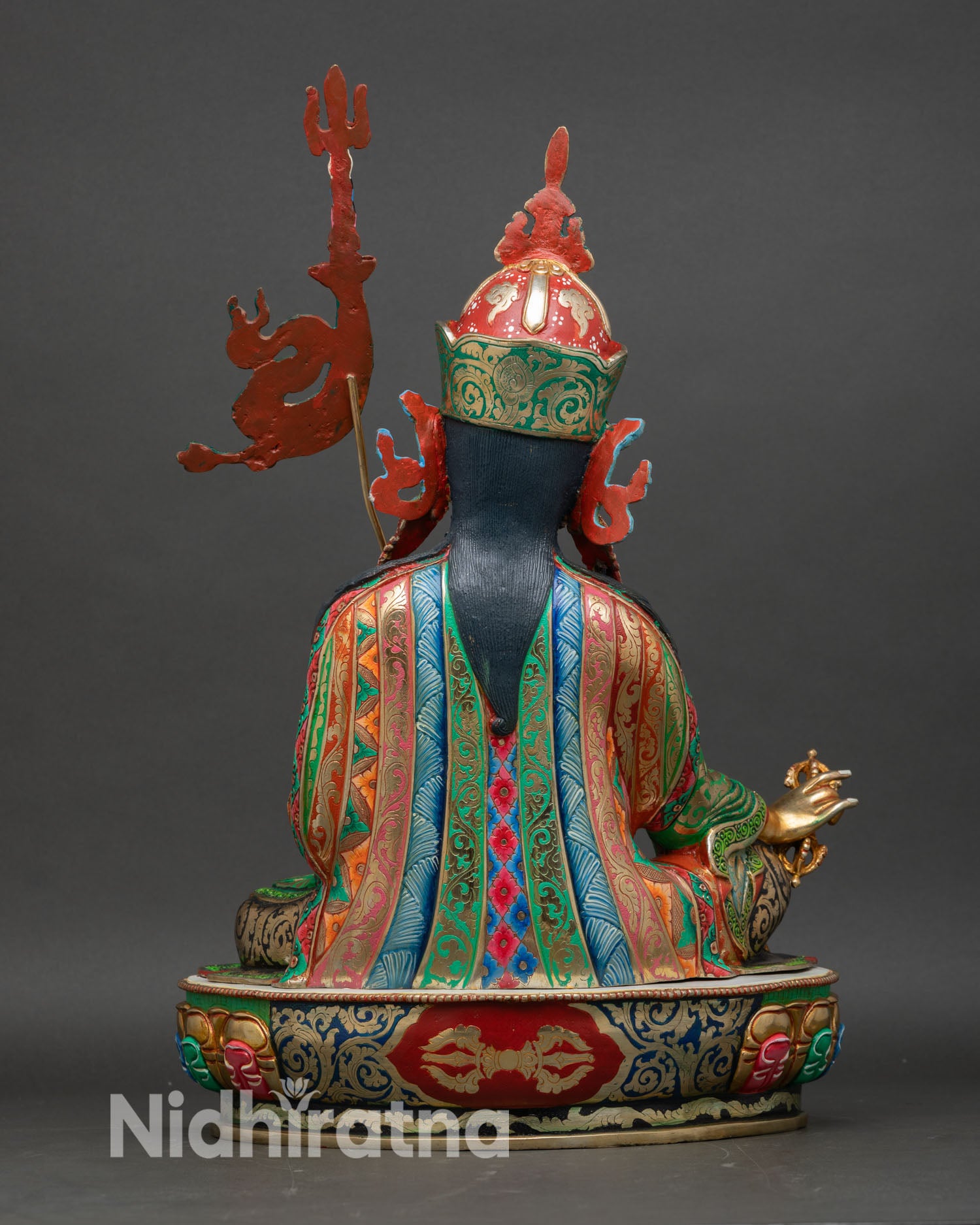 Back view of Guru Rinpoche statue with detailed robe carvings, lotus throne base, handcrafted Nepalese sculpture