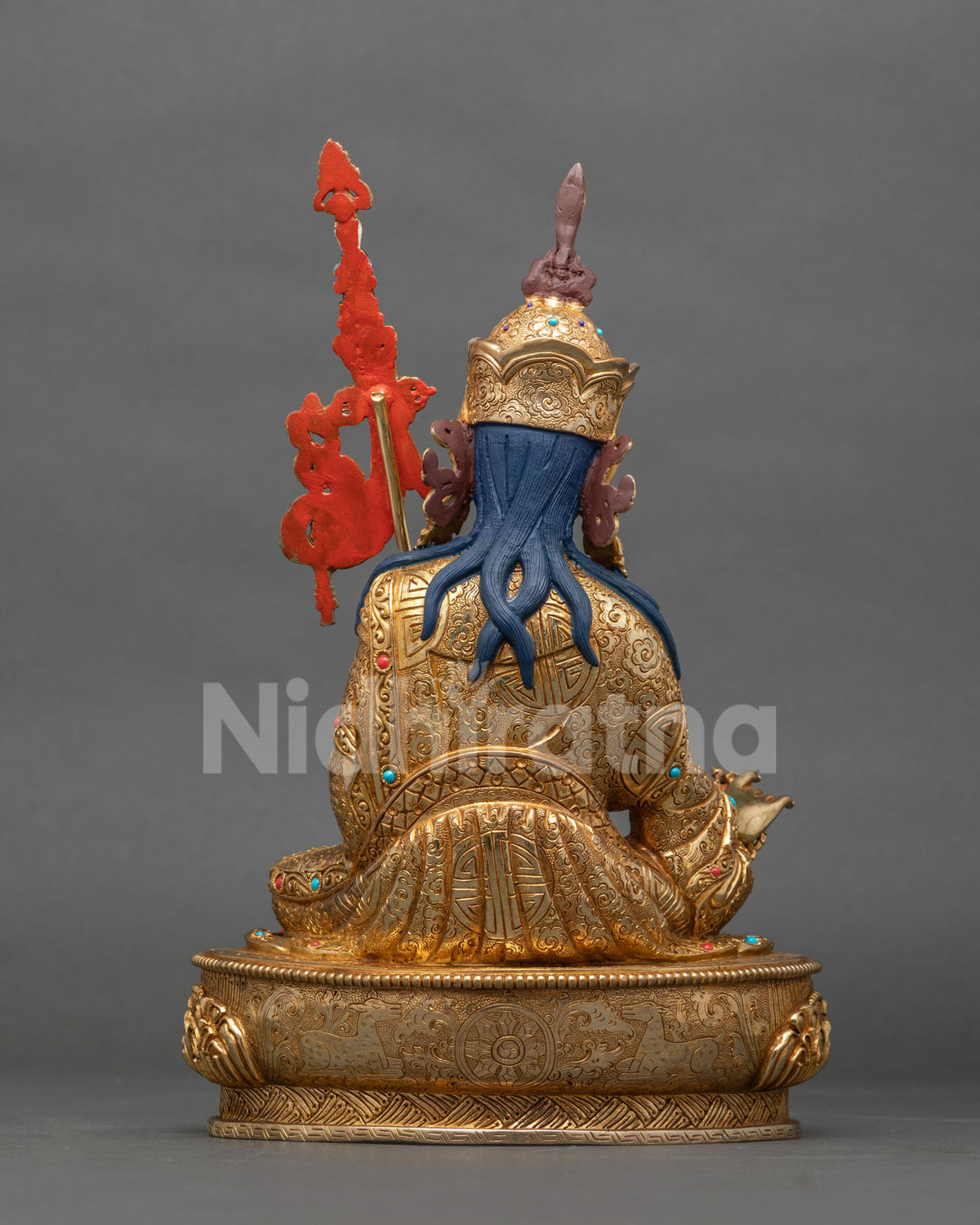 Back view of Guru Rinpoche statue with engraved robe and lotus pedestal in gold fire-gilded copper