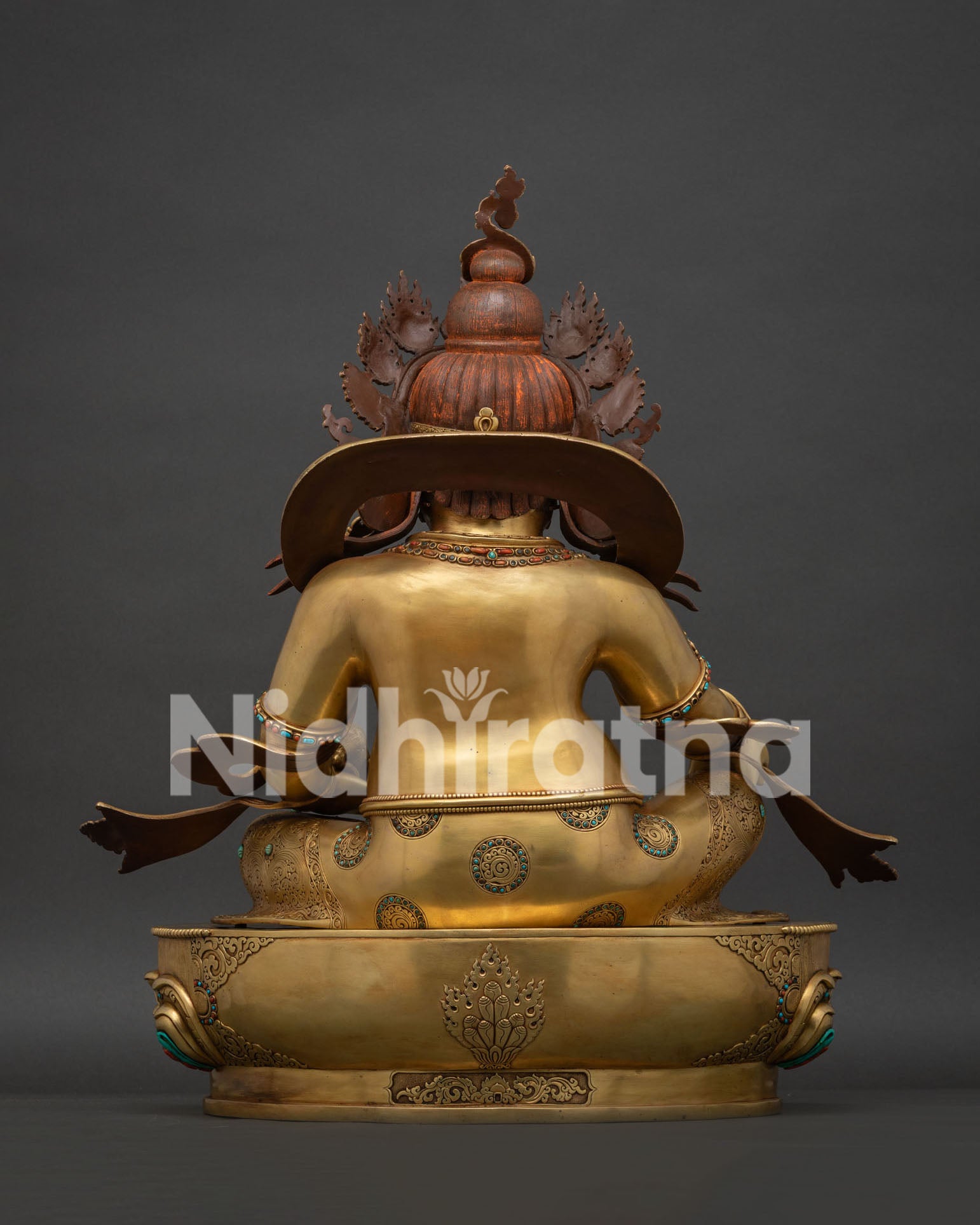 Back view of hand-carved gold fire-gilded copper Dzambhala Buddhist sculpture.