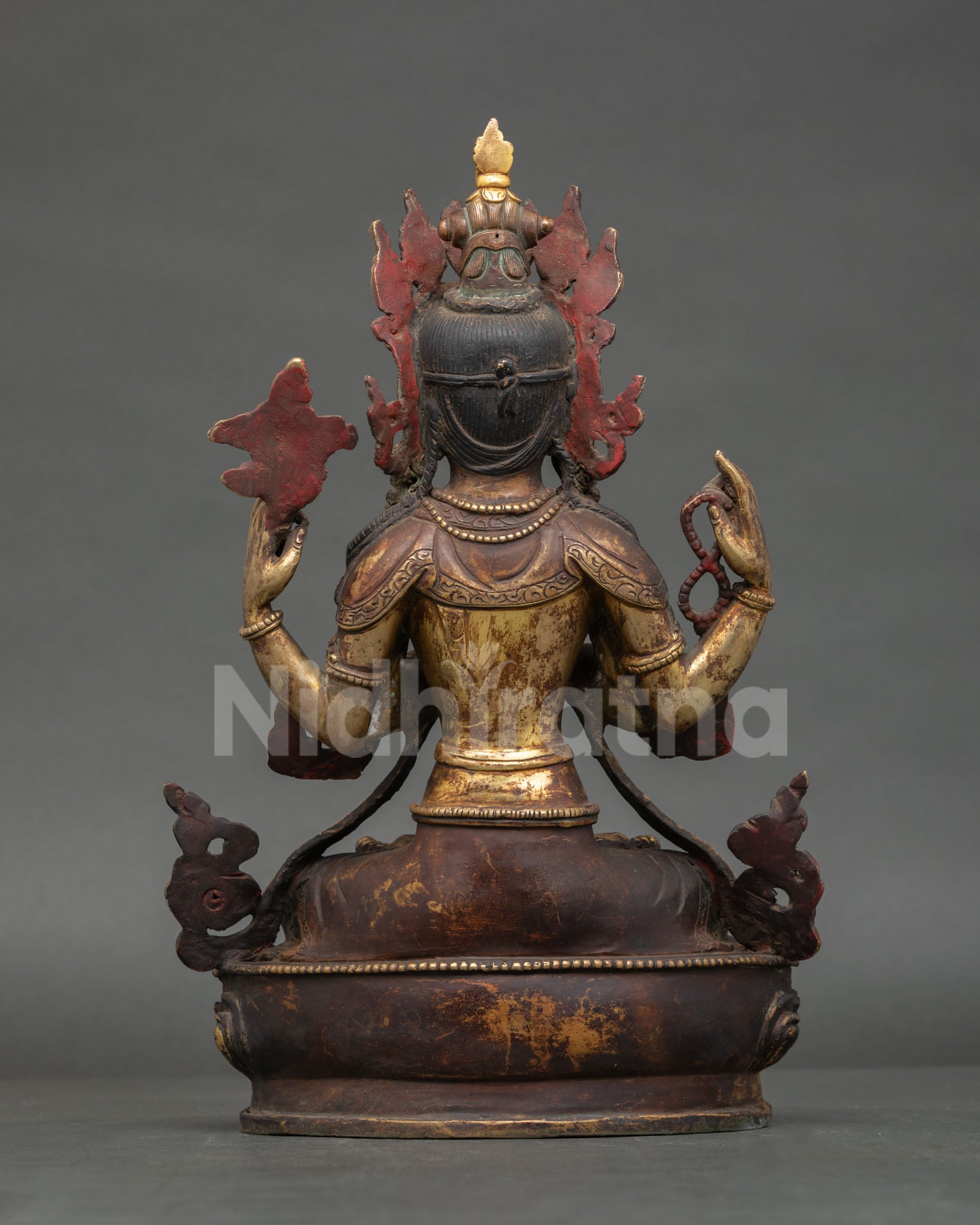 Back view of handcrafted Avalokiteshvara statue showing detailed robe patterns and copper work