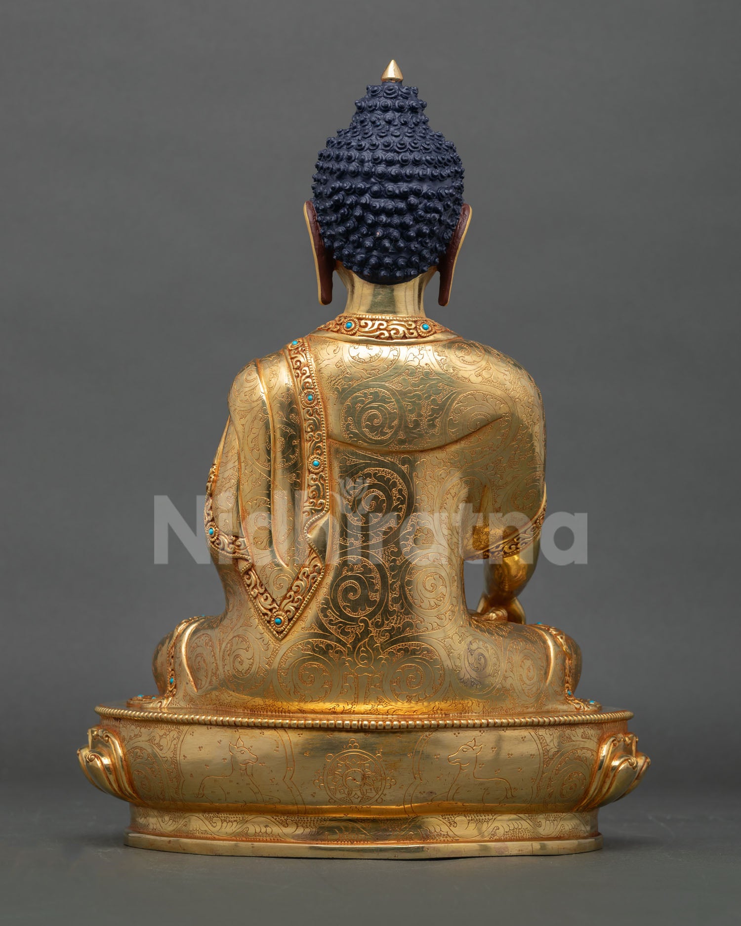 Back view of handcrafted Buddha statue from Nepal showcasing copper detailing gold accents and traditional Newari artisan workmanship