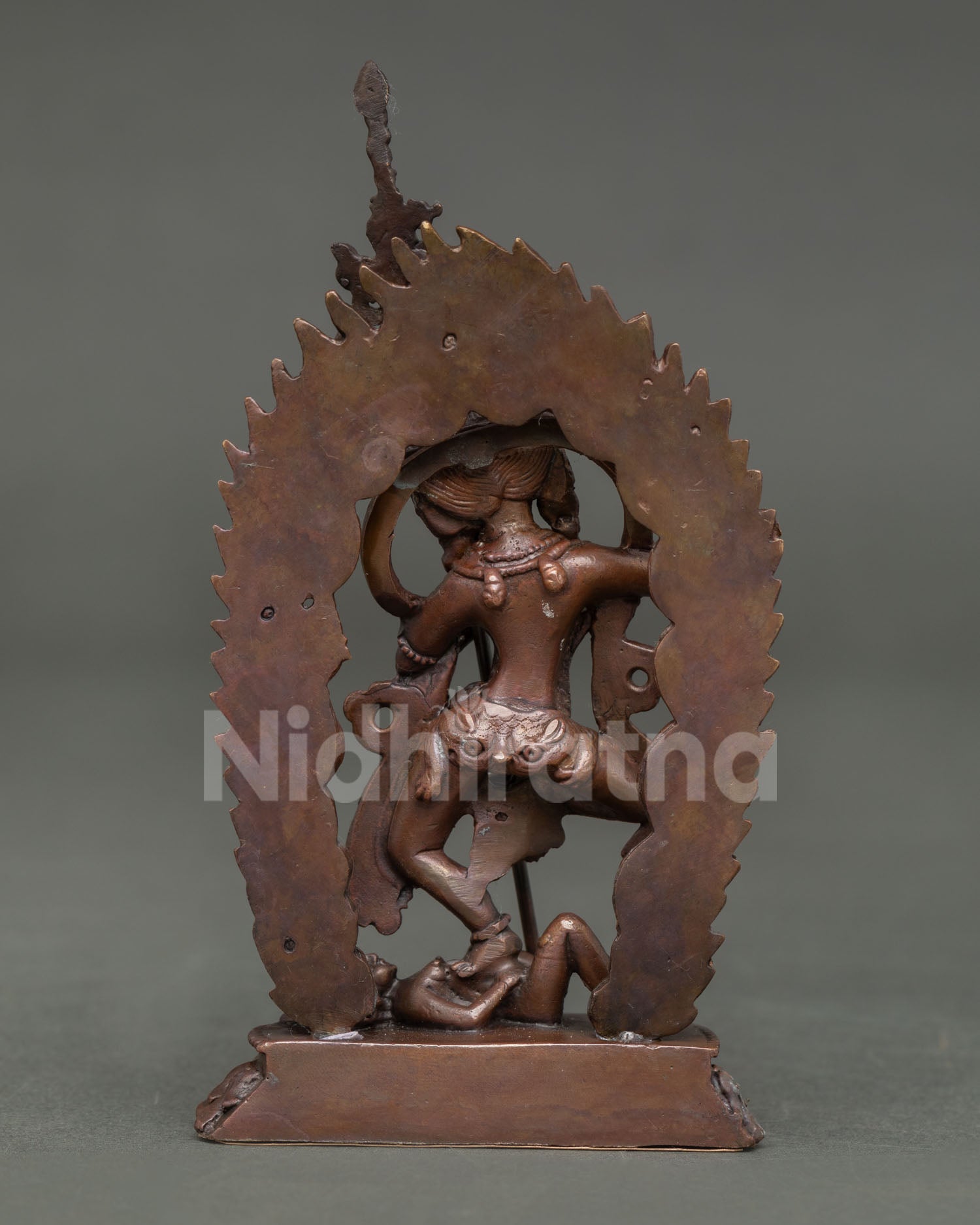 Back view of handcrafted Dorje Phagmo statue from Nepal showcasing intricate oxidized copper artistry