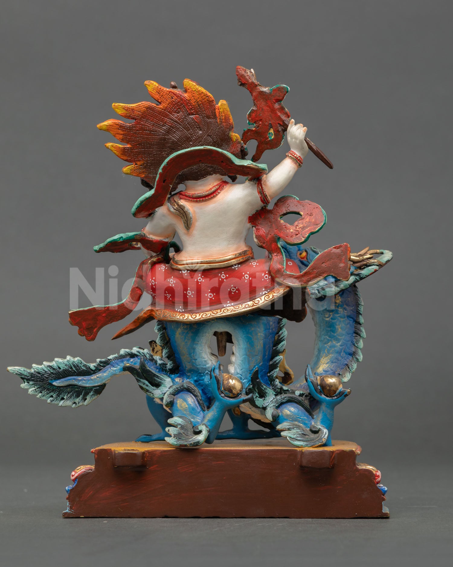 Back view of a handcrafted Dragon-riding Dzambhala statue showcasing traditional Himalayan Buddhist metal craftsmanship