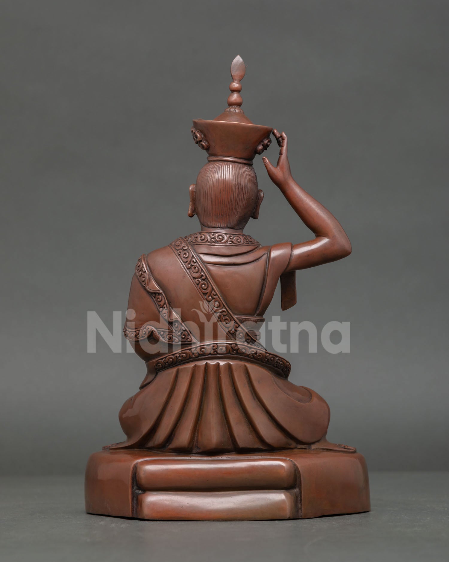 Back View of Handcrafted Karmapa Copper Statue with Intricate Robe Carvings.