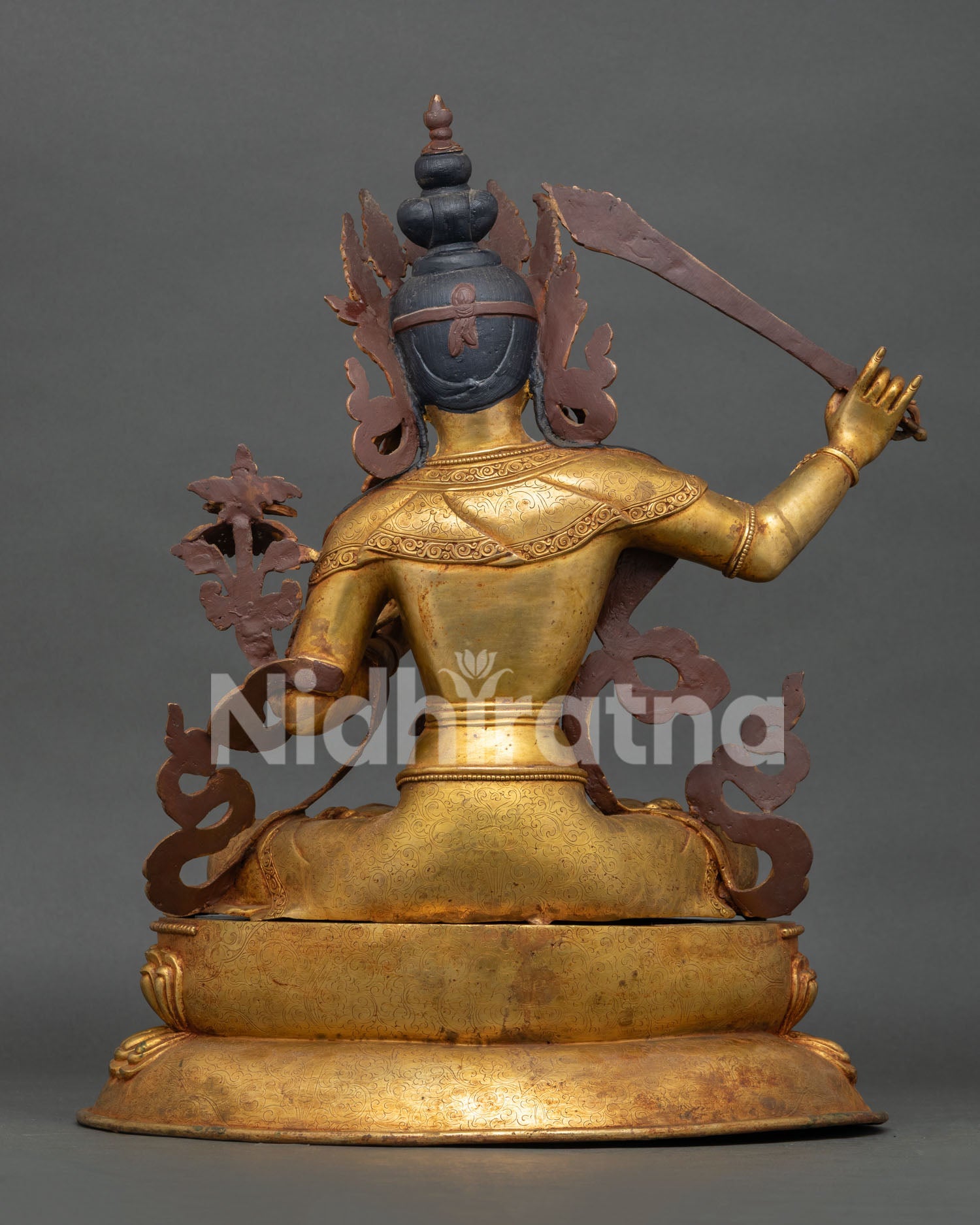 Back view of handcrafted Manjushri statue with gold gilded copper design and traditional Nepalese Buddhist craftsmanship