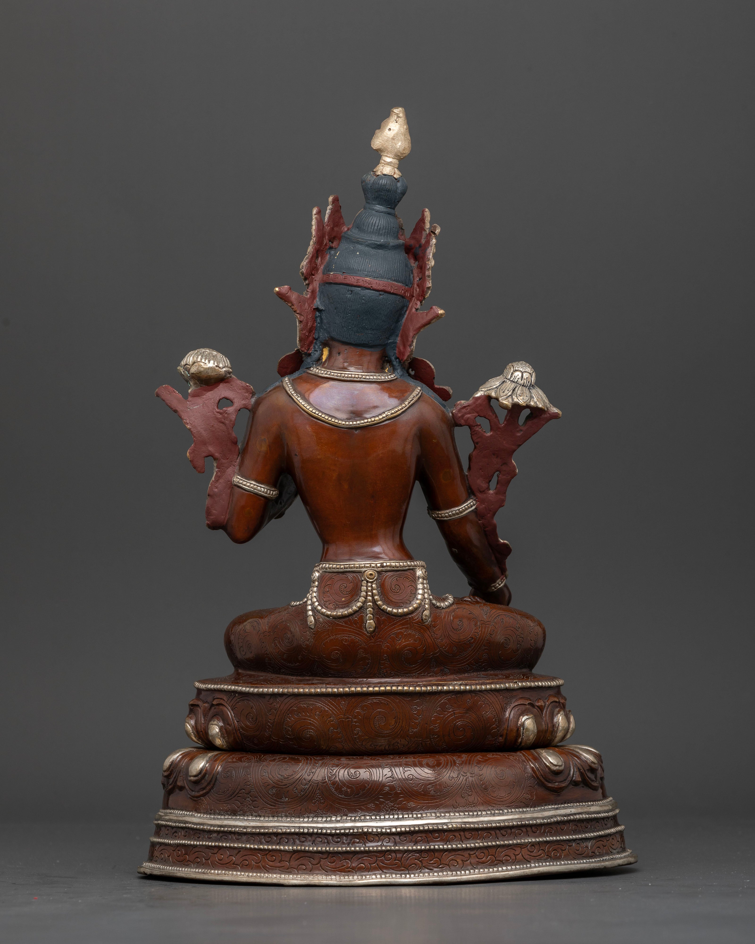 Back view of handcrafted White Tara oxidized copper statue with detailed robe carvings