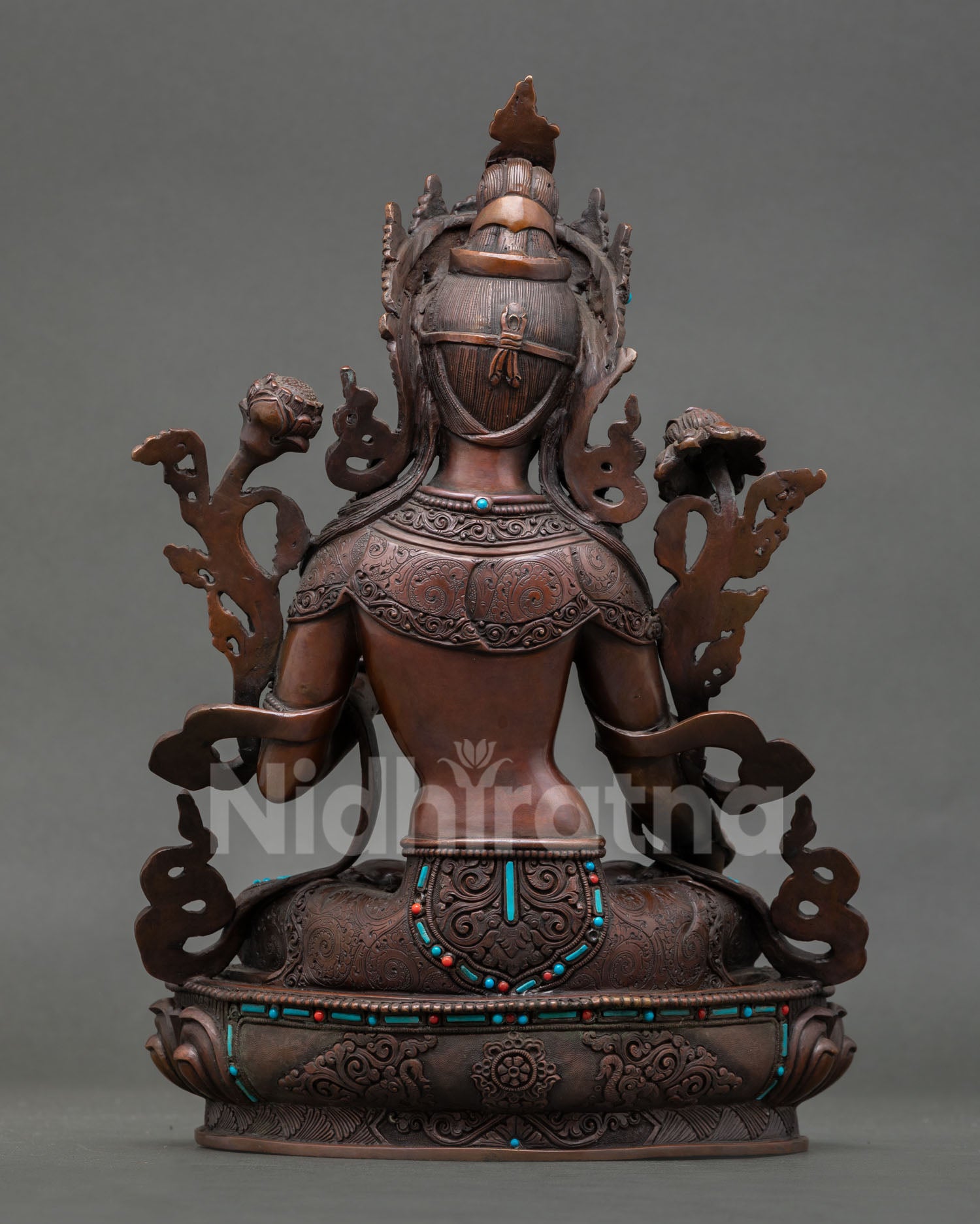 Back view of handcrafted White Tara statue from Patan Nepal showing oxidized copper detailing lotus pedestal craftsmanship and sacred Himalayan Buddhist devotional art