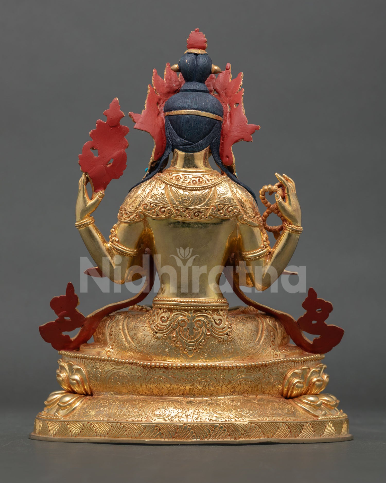 Back view of handmade Chenrezig statue from Patan Nepal with gold gilded copper finish and detailed Himalayan craftsmanship