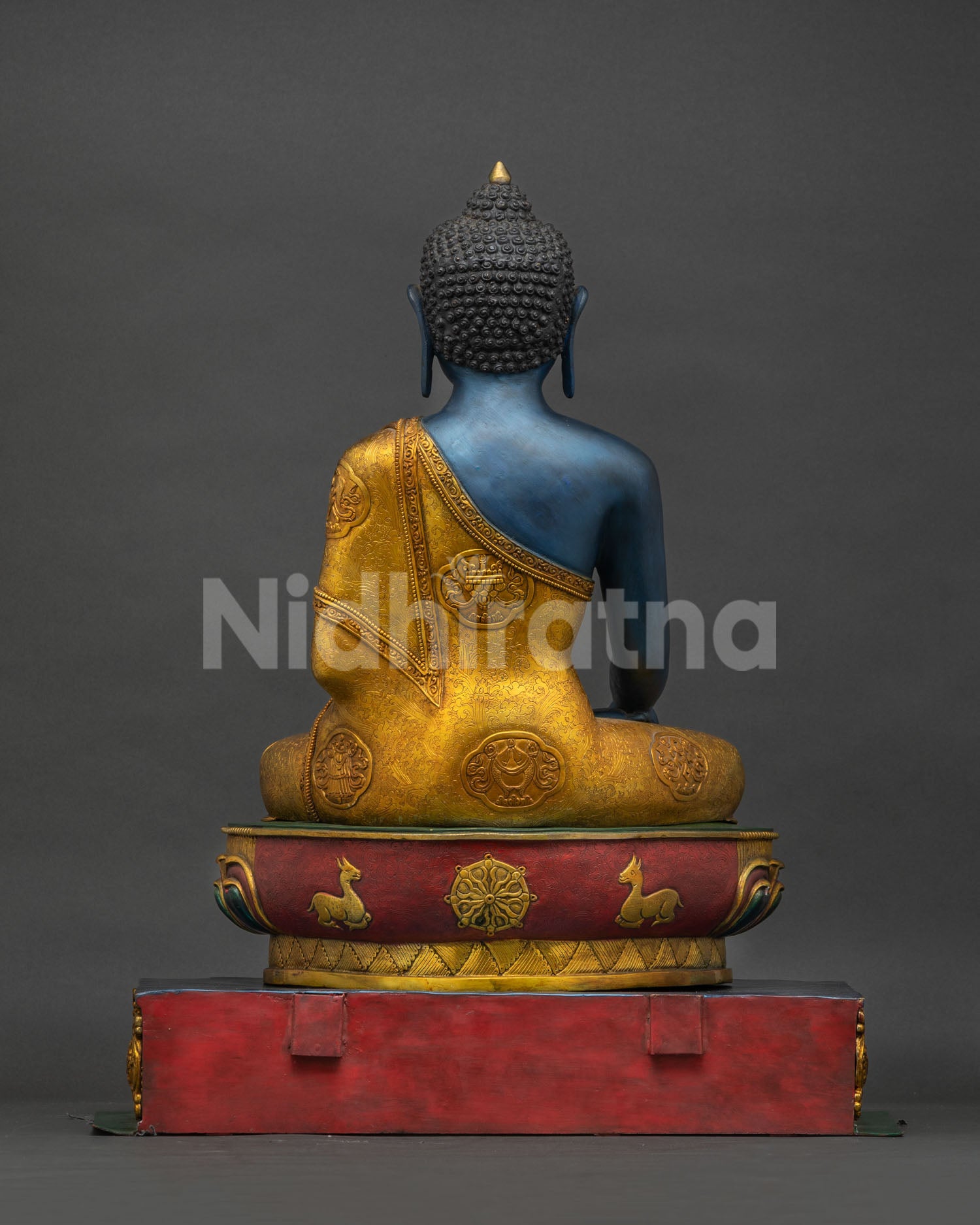 Back view of handmade copper Akshobhya Buddha statue with gold gilded throne from Nepal