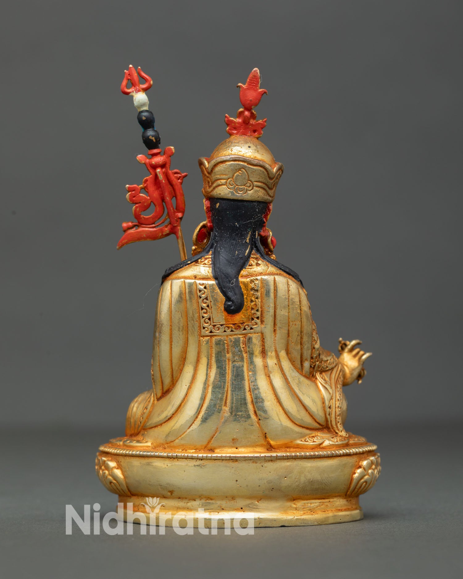 Back view of handmade Guru Rinpoche statue from Patan Nepal featuring ornate copper detailing lotus pedestal design and traditional Himalayan Buddhist artistry