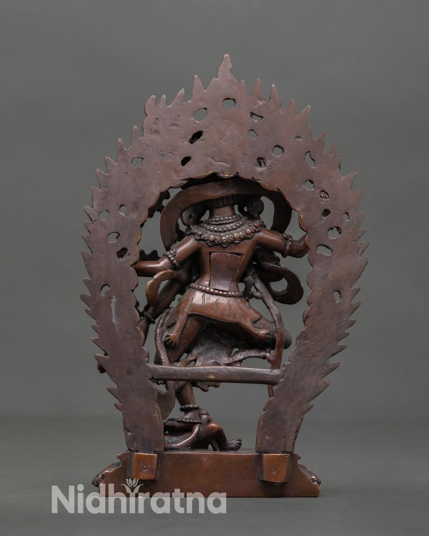 Back view of handmade Kurukulla statue from Patan Nepal featuring detailed copper carving lotus base and subdued figures