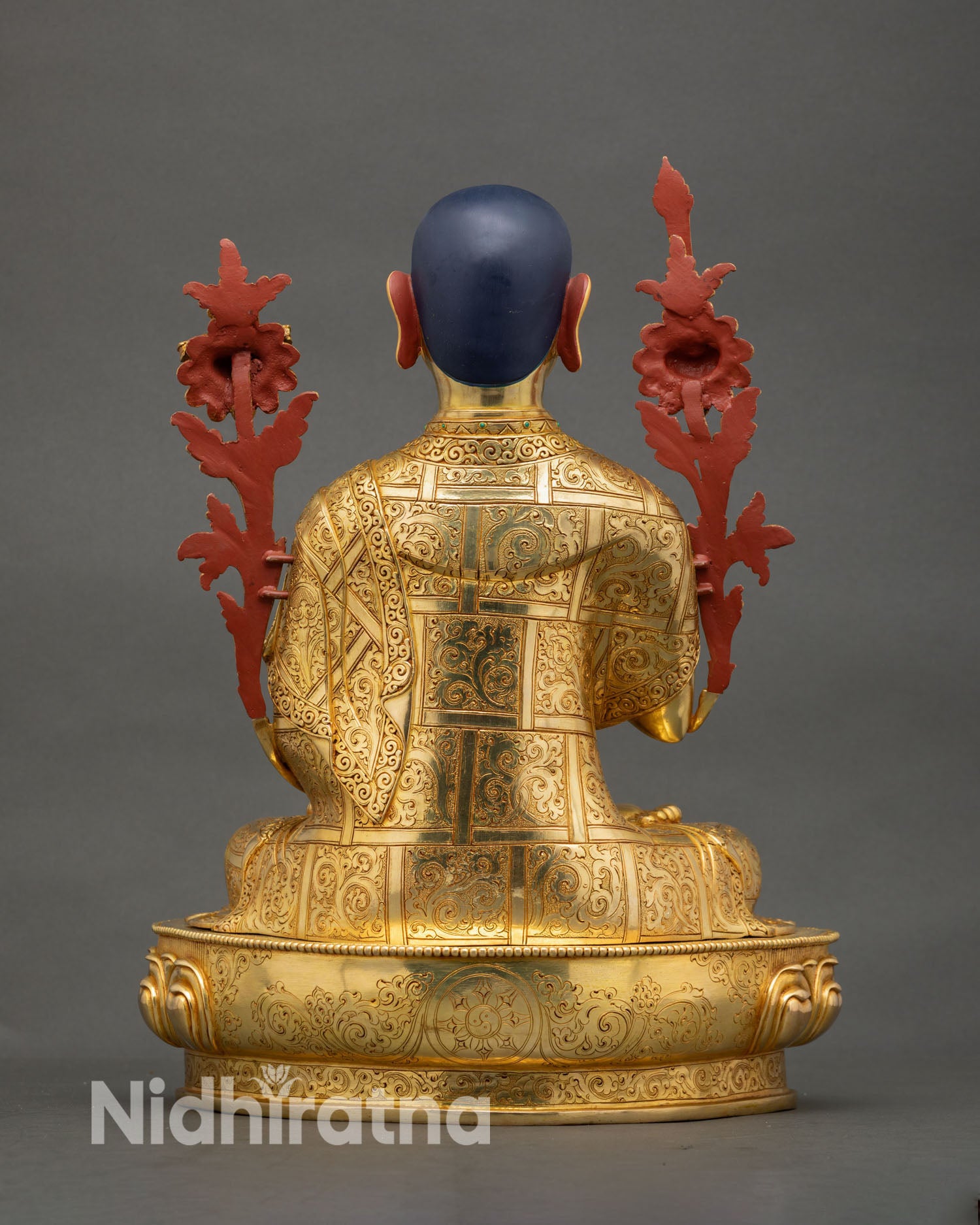 Back view of handmade Newari Je Tsongkhapa statue from Nepal with ornate copper engraving floral lotus base