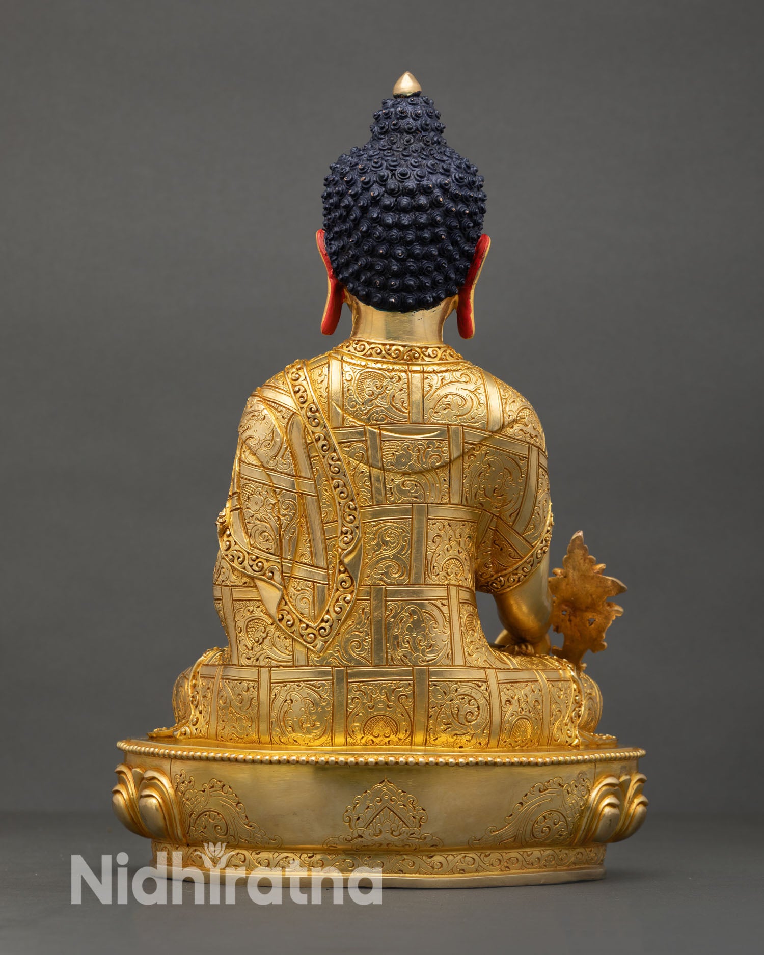 Back view of handmade Newari Medicine Buddha statue from Patan Nepal with intricate copper carving gold finish and spiritual altar decor details