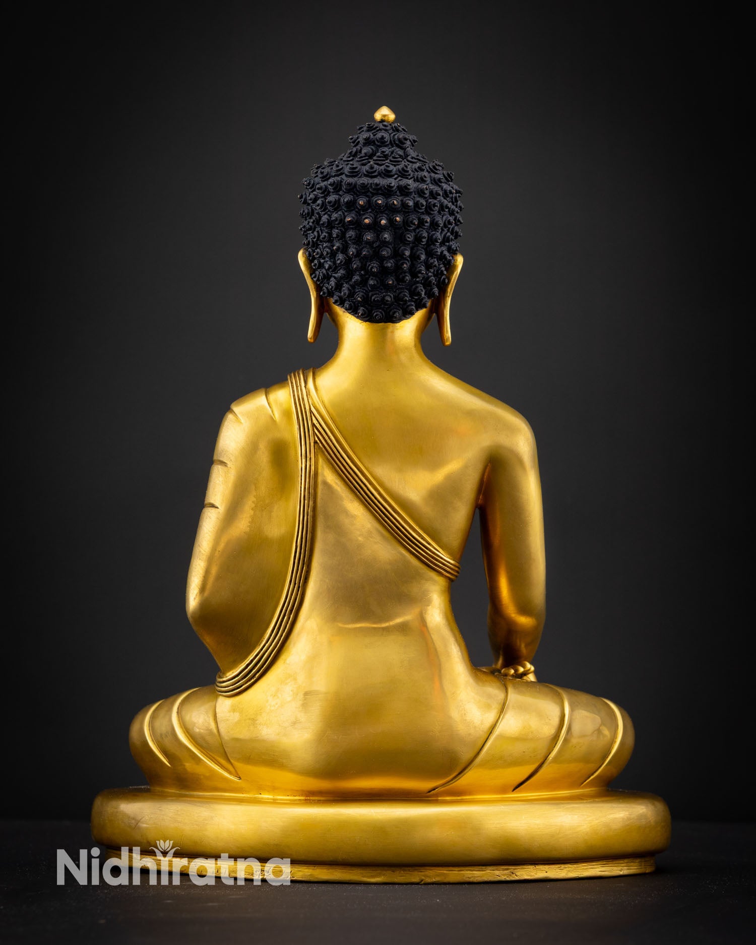 Back view of handmade Shakyamuni Buddha statue from Kathmandu Nepal featuring pure copper detailing gold gilded finish and sacred Buddhist altar presence
